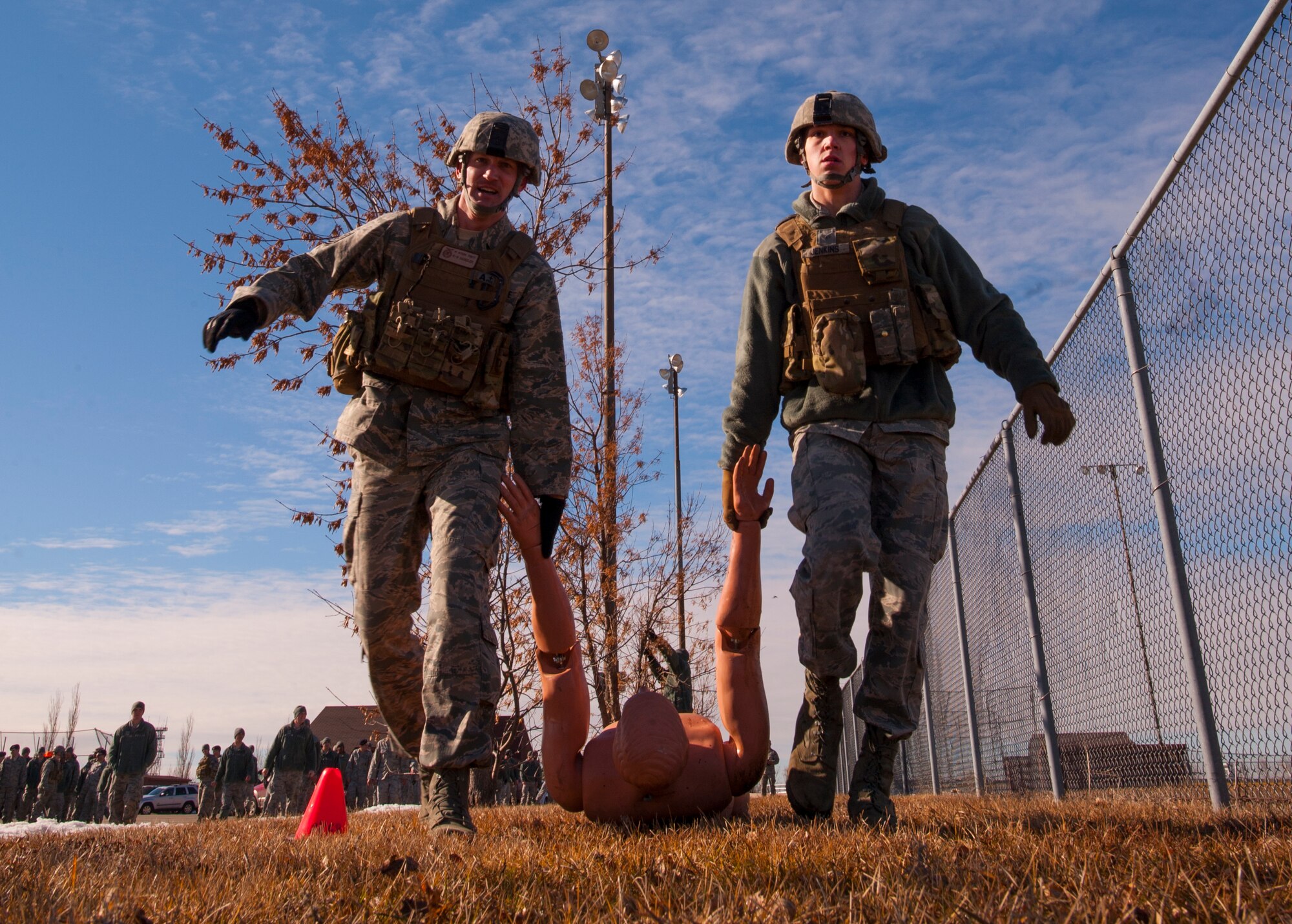 Tech. Sgt. Mitchell Stein and Senior Airman Derek Jenkins, 91st Missile Security Forces Squadron defenders, drag a training dummy during a Top Dog competition at Minot Air Force Base, N.D., March 12, 2014. The friendly competition allows defenders to practice training techniques while boosting morale. (U.S. Air Force photo/Airman 1st Class Apryl Hall)