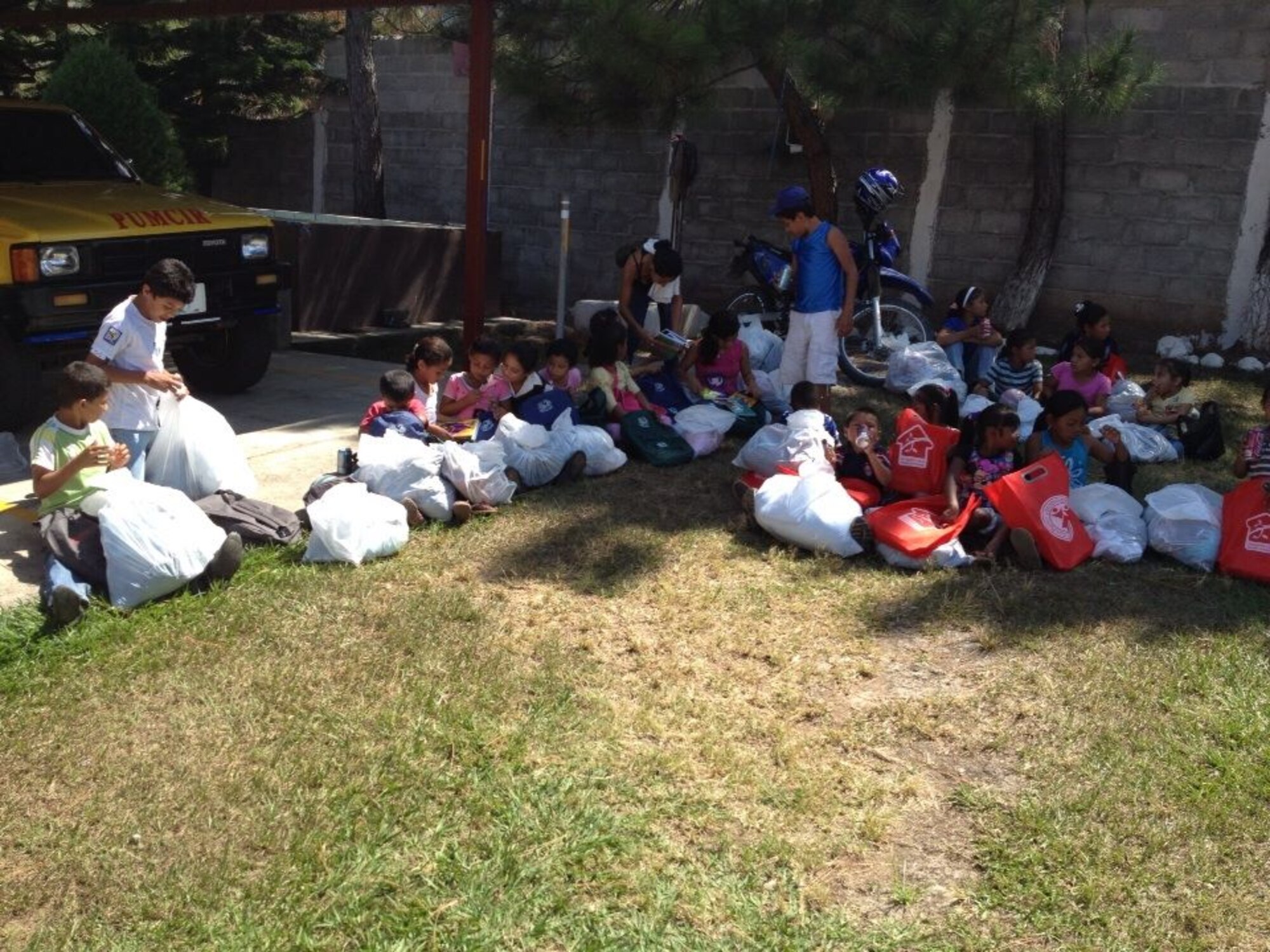 Children from the village of Mata de Patano, just outside of Comayagua, Honduras, receive clothes and backpacks that were donated by the 612th Air Base Squadron fire department, Joint Task Force-Bravo, clothes drive March 8, 2014.  The drive collected more than 275 sets of clothing and shoes that helped over 30 families.  (Courtesy photo)