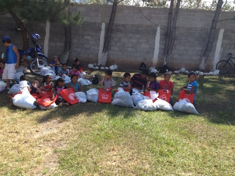 Children from the village of Mata de Patano, just outside of Comayagua, Honduras, receive clothes and backpacks that were donated by the 612th Air Base Squadron fire department, Joint Task Force-Bravo, clothes drive March 8, 2014.  The drive collected more than 275 sets of clothing and shoes that helped over 30 families.  (Courtesy photo)