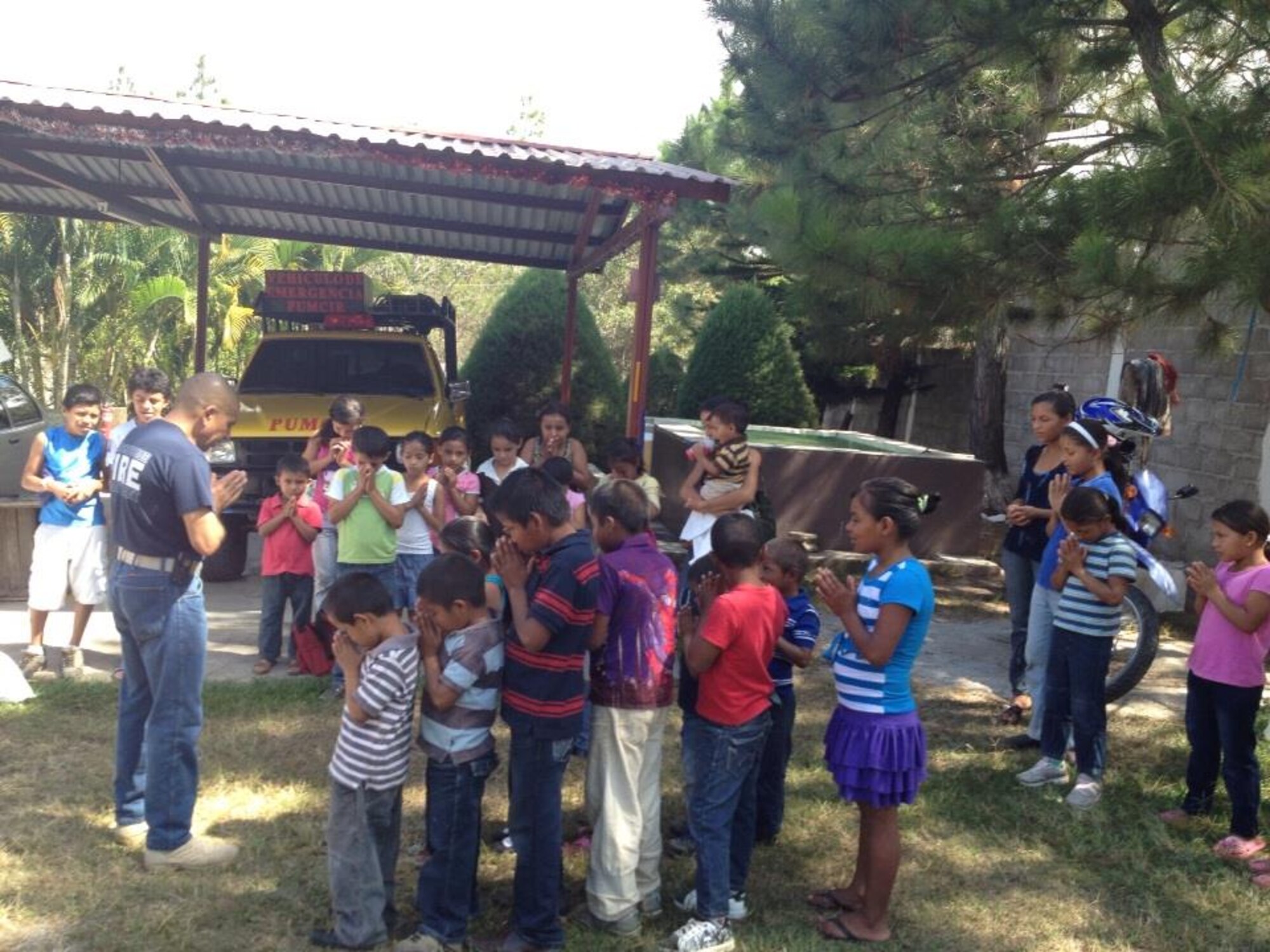 Children from the village of Mata de Patano, just outside of Comayagua, Honduras, receive clothes and backpacks that were donated by the 612th Air Base Squadron fire department, Joint Task Force-Bravo, clothes drive March 8, 2014.  The drive collected more than 275 sets of clothing and shoes that helped over 30 families.  (Courtesy photo)