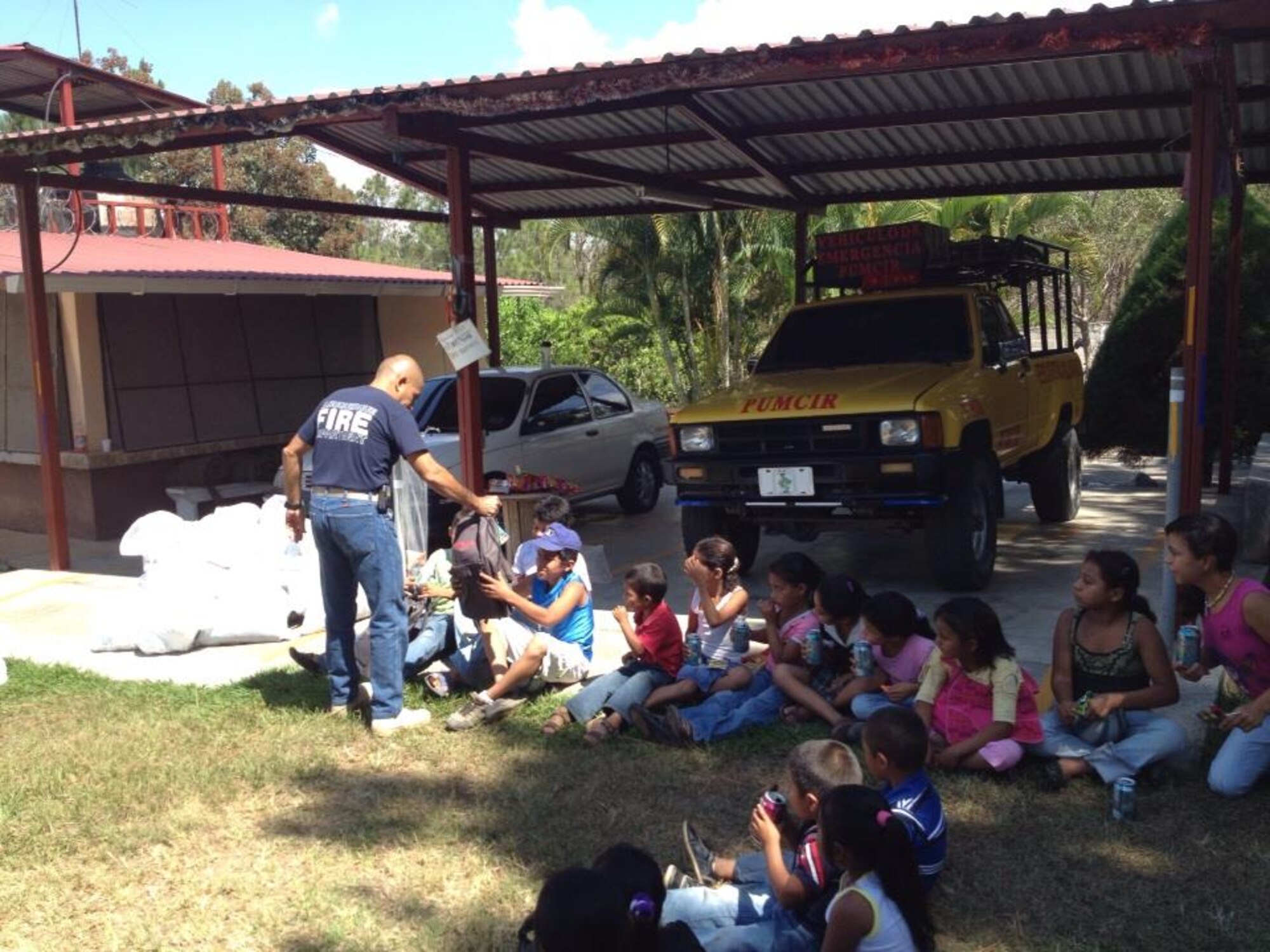 Children from the village of Mata de Patano, just outside of Comayagua, Honduras, receive clothes and backpacks that were donated by the 612th Air Base Squadron fire department, Joint Task Force-Bravo, clothes drive March 8, 2014.  The drive collected more than 275 sets of clothing and shoes that helped over 30 families.  (Courtesy photo)