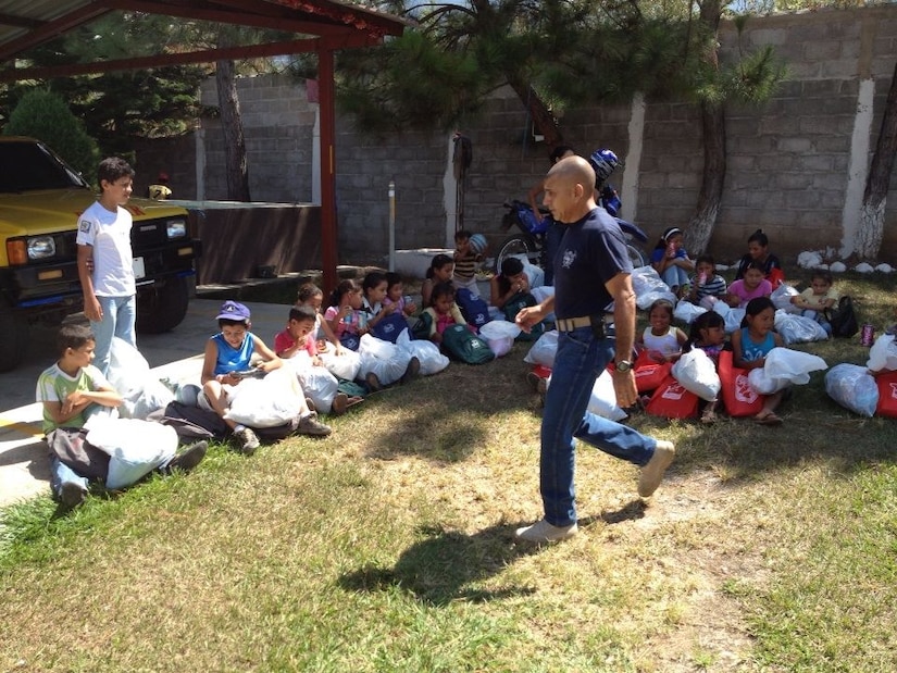 Children from the village of Mata de Patano, just outside of Comayagua, Honduras, receive clothes and backpacks that were donated by the 612th Air Base Squadron fire department, Joint Task Force-Bravo, clothes drive March 8, 2014.  The drive collected more than 275 sets of clothing and shoes that helped over 30 families.  (Courtesy photo)