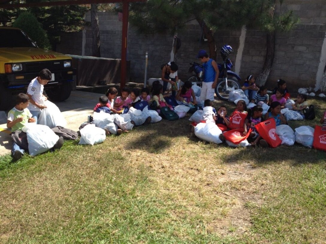 Children from the village of Mata de Patano, just outside of Comayagua, Honduras, receive clothes and backpacks that were donated by the 612th Air Base Squadron fire department, Joint Task Force-Bravo, clothes drive March 8, 2014.  The drive collected more than 275 sets of clothing and shoes that helped over 30 families.  (Courtesy photo)