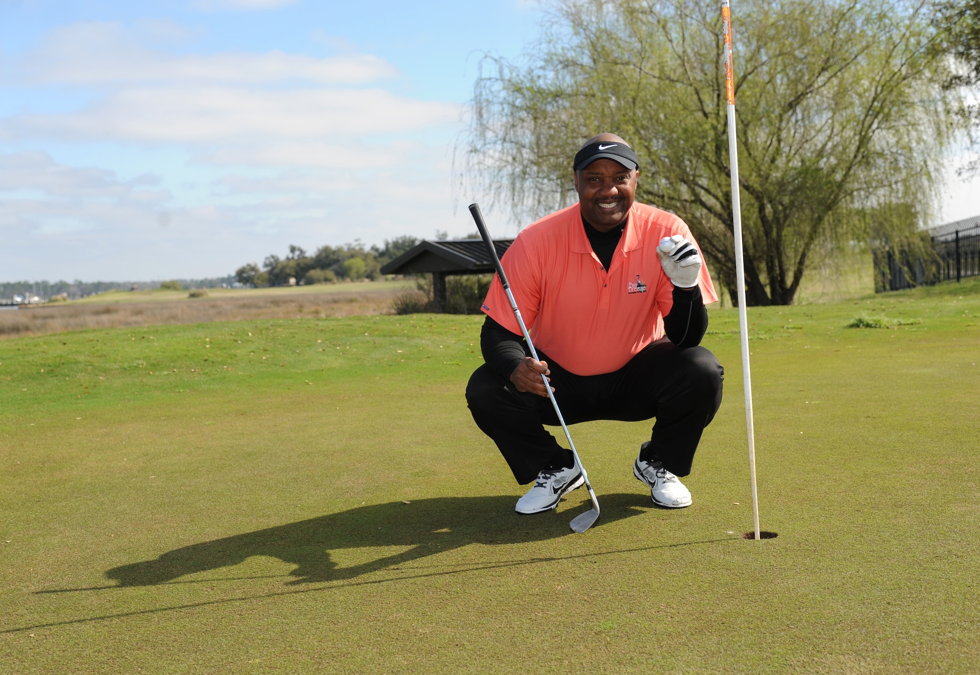 Ed Simpson Sr., 81st Training Support Squadron, takes a photo on Hole 12 March 18, 2014, at the Bay Breeze Golf Course, Keesler Air Force Base, Miss.  Simpson landed his first hole-in-one March 13.  (U.S. Air Force photo by Kemberly Groue)