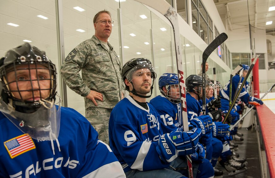 Honorary coach Chief Master Sgt. Wayne Deist and his team watch as the opposing White team attempts to take advantage of a power play during a Blue vs. White Fairchild Falcons Varsity Hockey team game with base leadership coaching at Eastern Washington University’s University Recreation Center in Cheney, Wash., March 14, 2014. (U.S. Air Force photo by Staff Sgt. Benjamin W. Stratton/Released)