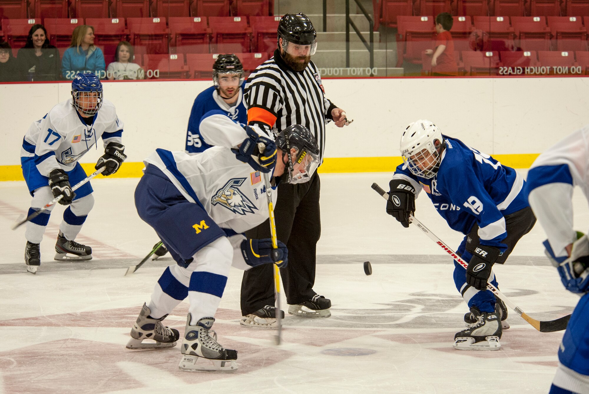 Players face off for puck control during a Blue vs. White Fairchild Falcons Varsity Hockey team game at Eastern Washington University’s University Recreation Center in Cheney, Wash., March 14, 2014. (U.S. Air Force photo by Staff Sgt. Benjamin W. Stratton/Released)