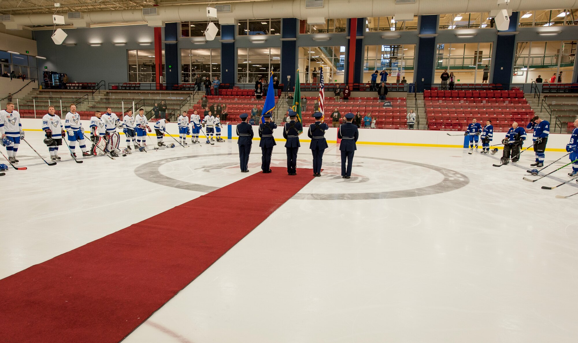 The Fairchild Honor Guard presents the colors at the start of a Blue vs. White Fairchild Falcons Varsity Hockey team game with base leadership coaching at Eastern Washington University’s University Recreation Center in Cheney, Wash., March 14, 2014. (U.S. Air Force photo by Staff Sgt. Benjamin W. Stratton/Released)