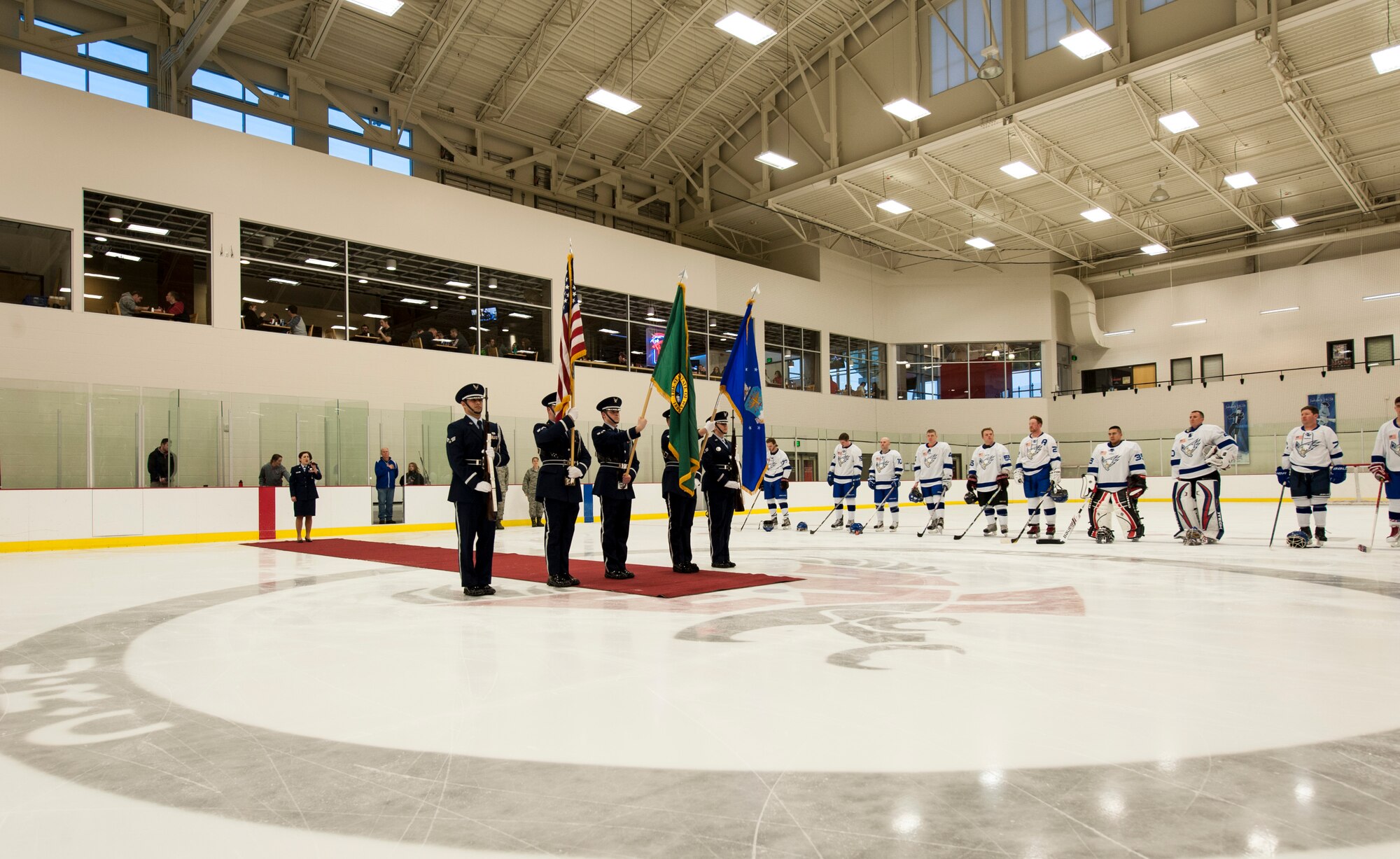 The Fairchild Honor Guard presents the colors as Staff Sgt. Brittany Ward sings the National Anthem at the start of a Blue vs. White Fairchild Falcons Varsity Hockey team game at Eastern Washington University’s University Recreation Center in Cheney, Wash., March 14, 2014. Ward is a 92nd Security Forces Squadron member. (U.S. Air Force photo by Staff Sgt. Benjamin W. Stratton/Released)