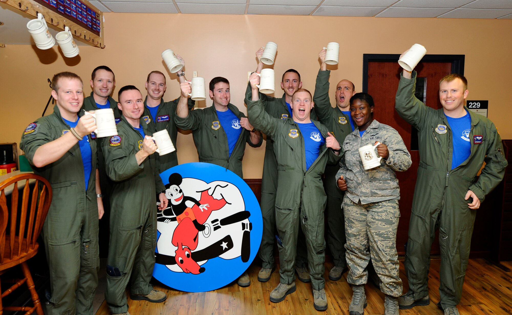 Airmen from the 349th Air Refueling Squadron show off their morale shirts in the squadron break room March 14, 2014, at McConnell Air Force Base, Kan. The large design in the center of the Airmen will be used as the squadron morale patch, which, in addition to the shirt, was recently approved for wear on Fridays in an update to Air Force instruction 36-2903. (U.S. Air Force photo/Airman 1st Class Victor J. Caputo)