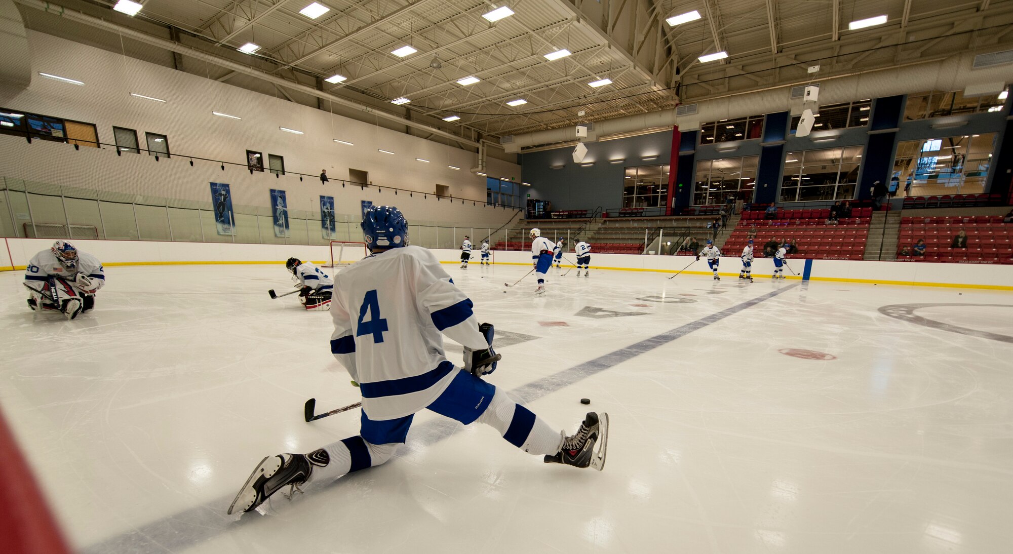 The White team stretches before a Blue vs. White Fairchild Falcons Varsity Hockey team game at Eastern Washington University’s University Recreation Center in Cheney, Wash., March 14, 2014. (U.S. Air Force photo by Staff Sgt. Benjamin W. Stratton/Released)