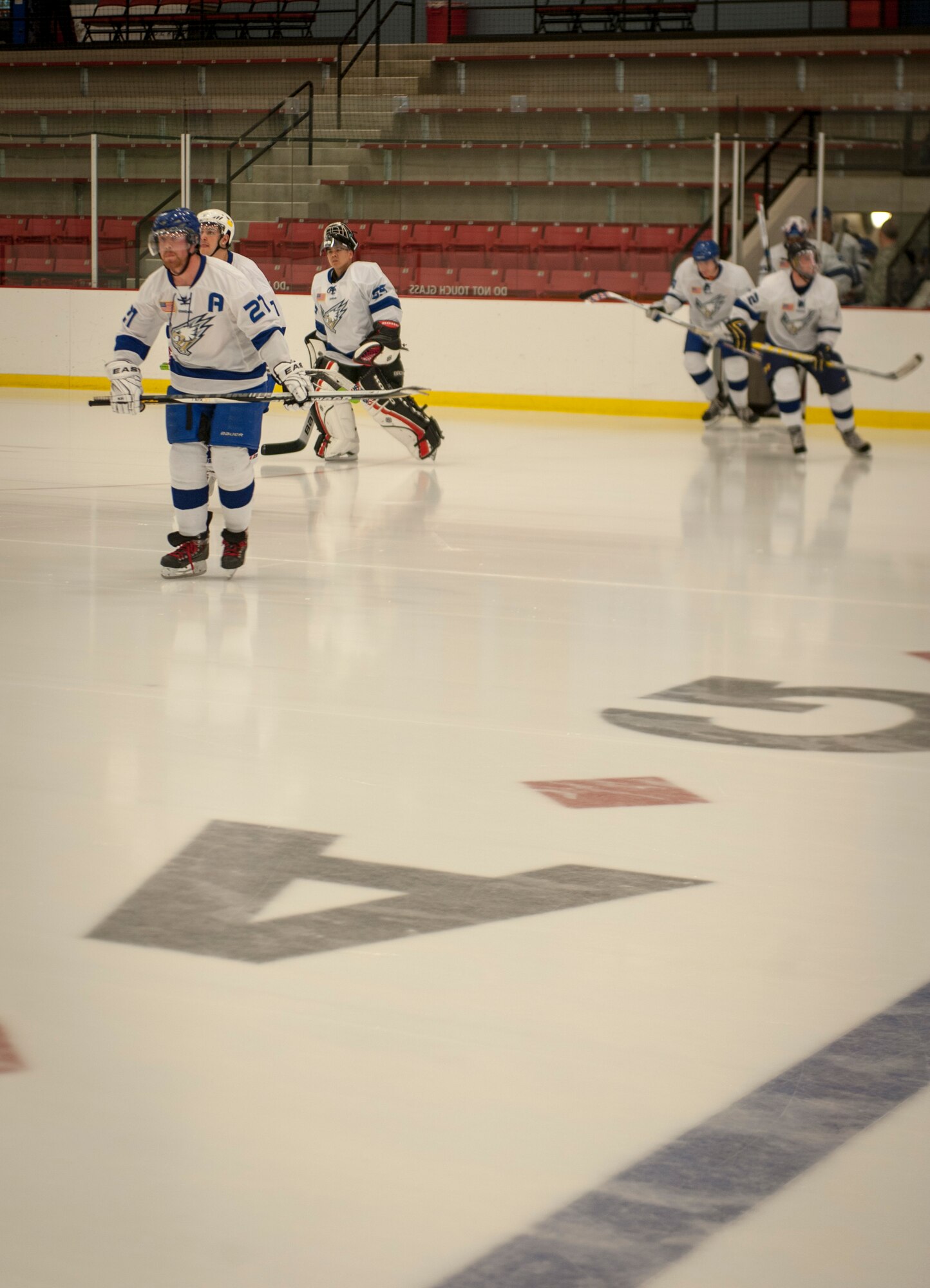The White team takes to the ice for a Blue vs. White hockey game matching up the top two from each Team Fairchild wing as squad coaches at Eastern Washington University’s University Recreation Center in Cheney, Wash., March 14, 2014. Col. Brian Newberry and Chief Master Sgt. Wendy Hansen, the 92nd Air Refueling Wing commander and command chief led the White team as they squared off against the Blue team led by Col. Daniel Swain and Chief Master Sgt. Wayne Deist, the 141st Air Refueling Wing commander and command chief. (U.S. Air Force photo by Staff Sgt. Benjamin W. Stratton/Released)