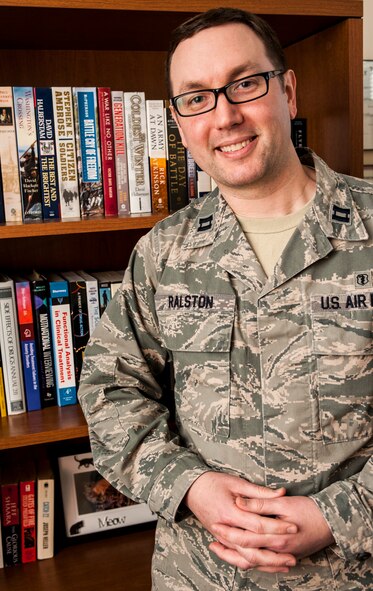 Capt. Tim Ralston, 5th Medical Group mental health element leader, stands near his bookcase at Minot Air Force Base, N.D., March 10, 2014. The Mental health clinic currently has three full-time mental health providers who spend approximately 25 hours with patients weekly, as well as four half time psychiatrists who are able to spend about 12 hours with patients per week. (U.S. Air Force photo/Senior Airman Stephanie Sauberan)