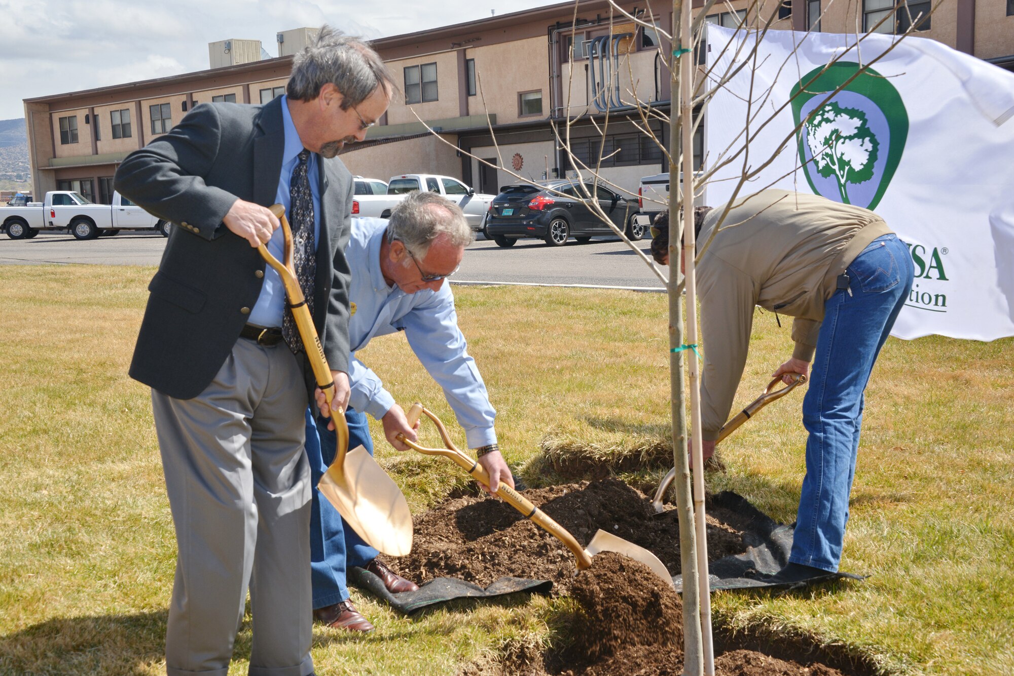 From left, John Pike, 377th Civil Engineer Division; Rick Farrin, 377th Force Support Squadron and Lawrence Crane, New Mexico State Forestry Division plant a Modesto Ash March 14 at the southwest side of the Mountain View Club in recognition of Kirtland attaining Tree City status through the Arbor Day Foundation.  Kirtland has achieved that national designation for the past 15 years. (Photo by Dennis Carlson)