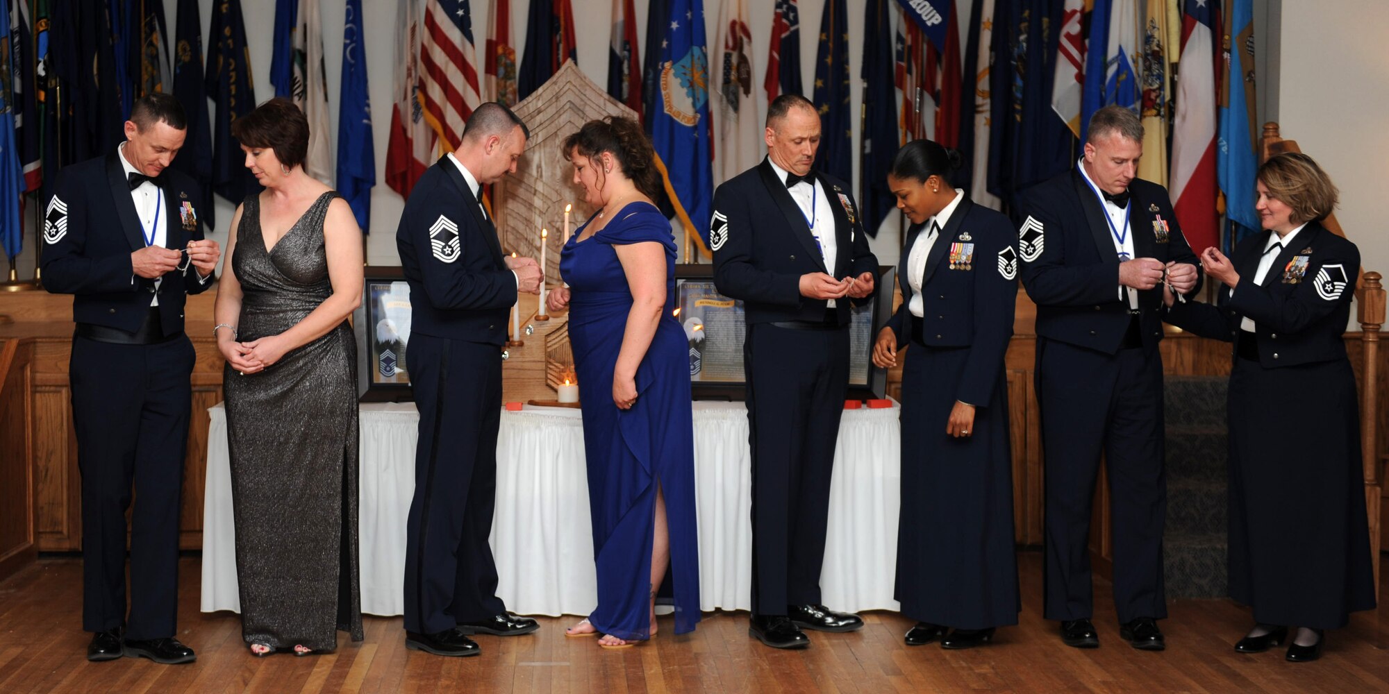 Chief master sergeant inductees place a bracelet on their wives’ wrists during the Chief Induction Ceremony March 14, 2014 at Dyess Air Force Base, Texas. The bracelet is a gift from the chiefs, symbolizing the appreciation for the dedication and support they receive from their spouses.(U.S. Air Force photo by Airman 1st Class Autumn Velez/Released)