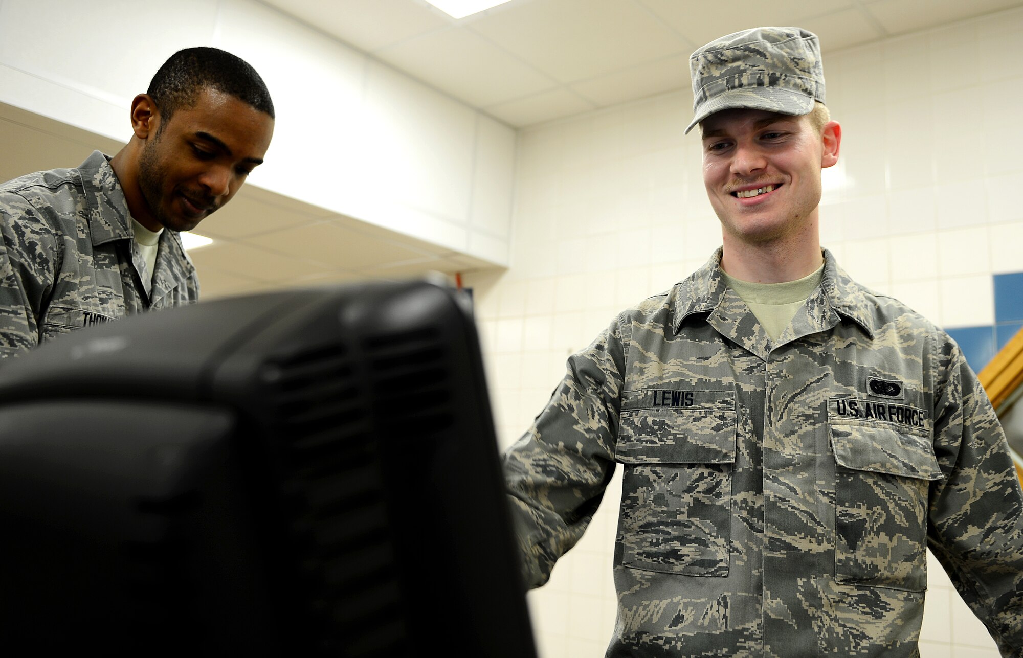 Airman 1st Class Michael Lewis, 48th Force Support Squadron food service apprentice, serves customers at the Knights’ Table Dining Facility, at Royal Air Force Lakenheath, England, Mar. 18, 2014. Lewis was nominated for a Liberty Spotlight because he displays the core value of Excellence in All We Do. (U.S. Air Force photo by Airman 1st Class Dawn M. Weber/Released)  