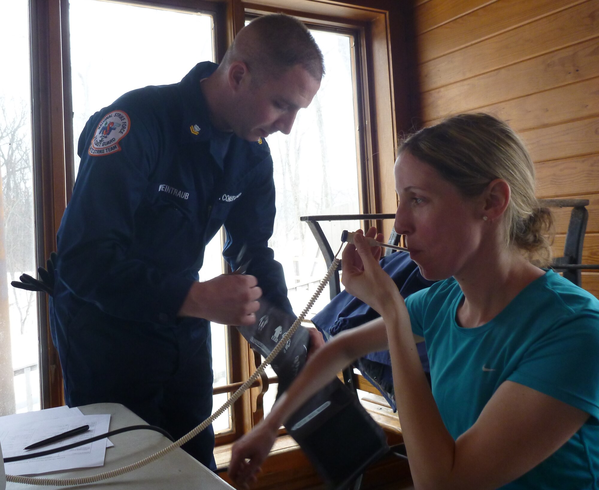 Petty Officer Second Class Steve Weintraub, an emergency medical technician with the U.S. Coast Guard Atlantic Strike Team, provides medical monitoring support for an Environmental Protection Agency on-scene commander before making entries into a simulated hazardous material environment during an annual exercise on March 11, 2014, in Angola, Ind. (U.S. Coast Guard photo by Petty Officer Second Class Paulina Halasa/Released)
