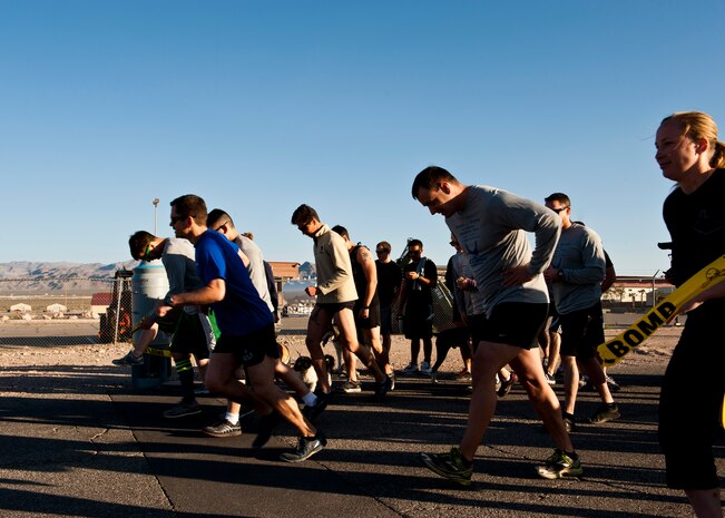 Participants in the 4th Annual Michael J. Buras Memorial Run begin the 5 Kilometer run on March 15, 2014, at Nellis Air Force Base, Nev. Senior Airman Michael Buras was an explosive ordinance disposal specialist assigned to the 99th Civil Engineer Squadron. Buras was killed by an improvised explosive device on September 21, 2010 in the Kandahar region of Afghanistan. (U.S. Air Force photo by Airman 1st Class Thomas Spangler)