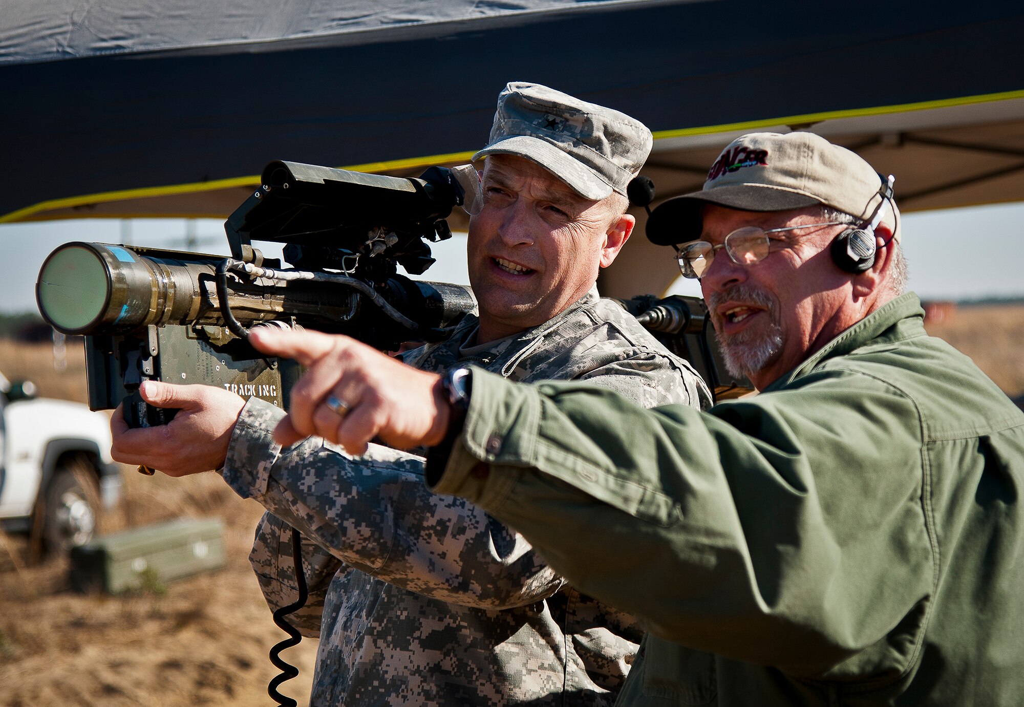 Brig. Gen. Neil Thurgood, the program executive officer missiles and space, receives some pre-fire FIM-92 Stinger training from Jerry Haney, of Raytheon Missile Systems, during testing March 14 at Eglin Air Force Base, Fla.  The general fired the first test shot of the day and connected with an aerial target drone.  Stinger Based Systems, a division of the Army’s cruise missile defense system unit, test-fired more than 30 Stingers at aerial and fixed targets on the base’s range throughout the week.  (U.S. Air Force photo/Samuel King Jr.)