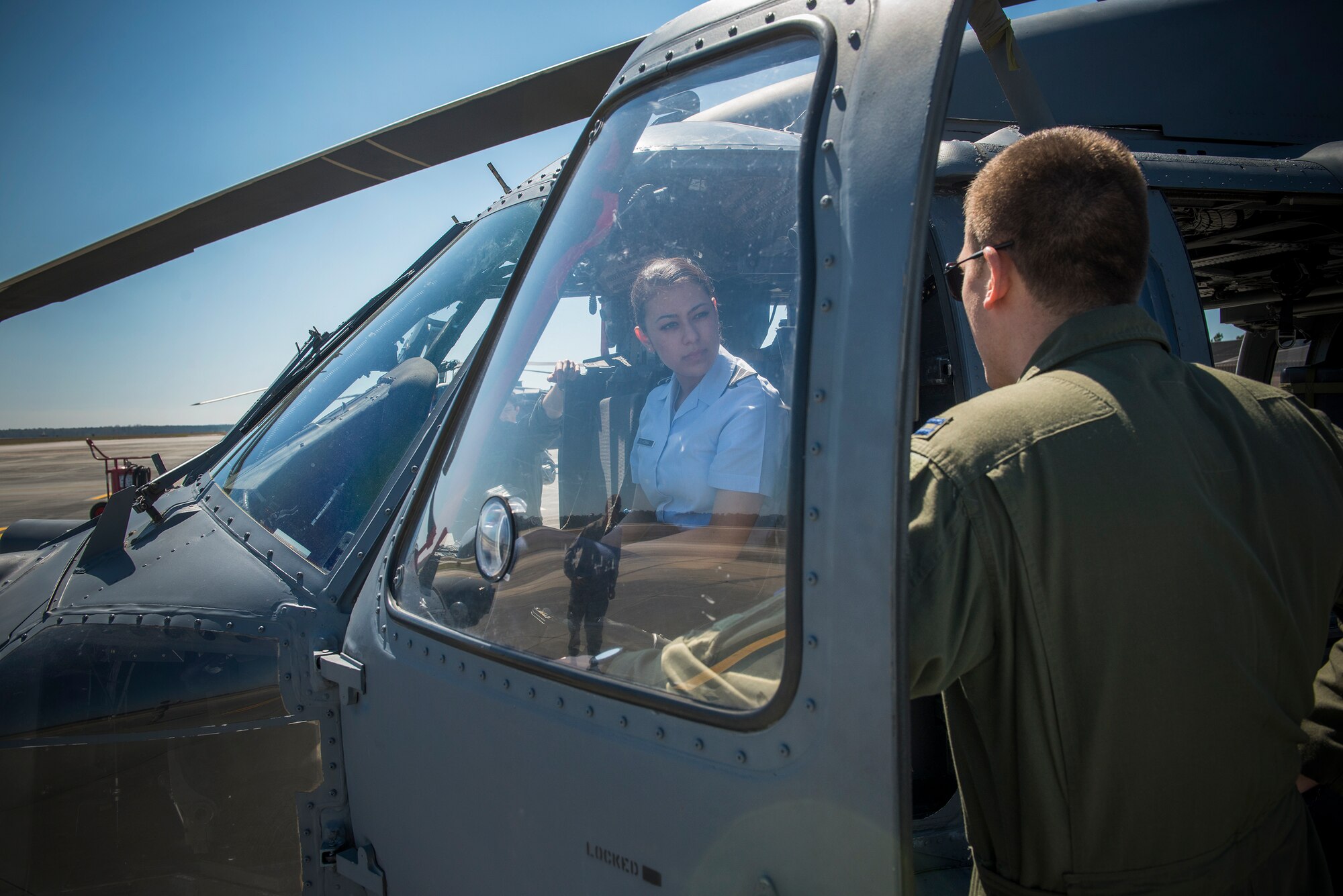 Vanessa Hosaka, U.S. Air Force Reserve Officer Training Corps cadet, talks with U.S. Air Force Capt. Jonathan Gokey, 41st Rescue Squadron HH-60G Pave Hawk pilot, during a base tour at Moody Air Force Base, Ga., March 14, 2014. Hosaka spoke with Gokey about her desire to be an HH-60 pilot. (U.S. Air Force photo by Senior Airman Douglas Ellis/Released)
