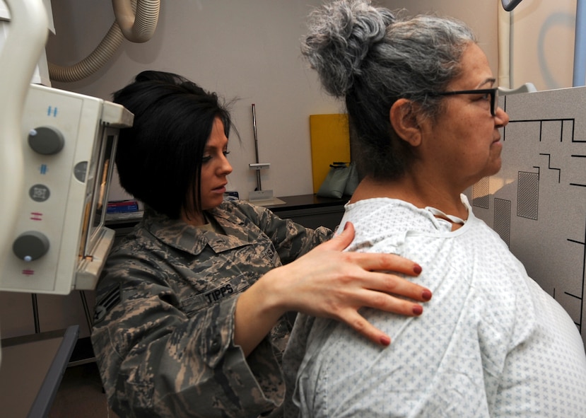 U.S. Air Force Senior Airman Kelly Tipps, 7th Medical Support Squadron diagnostic imaging technician, adjusts Sylvia Urban for an X-ray March 14, 2014, at Dyess Air Force Base, Texas. Diagnostic imaging technicians provide image production and interpretation for Team Dyess. (U.S. Air Force photo by Senior Airman Peter Thompson/Released)