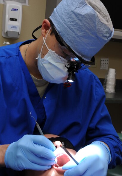 U.S. Air Force Airman 1st Class Cody Hyde, 7th Aerospace Medicine Squadron dental technician, examines Staff. Sgt. Yvonne Febles-Rosario’s teeth, 7th Medical Operations Squadron, March 14, 2014, at Dyess Air Force Base, Texas. The dental clinic has maintained a 97 percent readiness rate for approximately 4,800 patients. On average, the dental clinic provides services to more than 85 customers each day. (U.S. Air Force photo by Senior Airman Peter Thompson/Released)