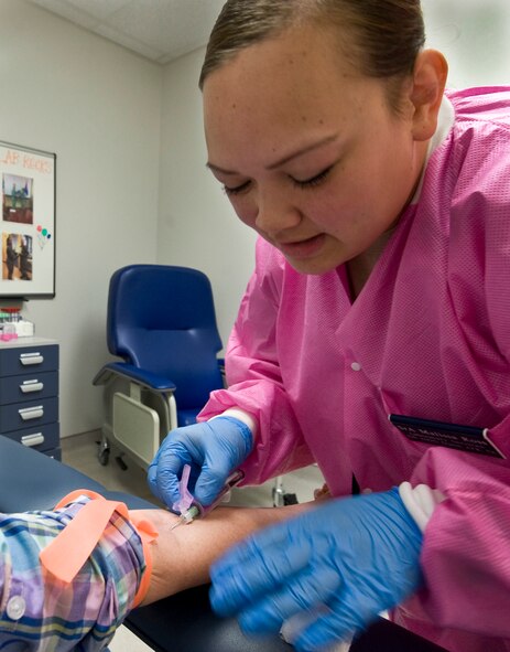 U.S. Air Force Senior Airman Malissa Ross, 7th Medical Support Squadron medical laboratory assistant, performs a phlebotomy March 14, 2014, at Dyess Air Force Base, Texas. The clinic laboratory serves all active duty, dependents and retirees at Dyess and the surrounding areas.  Every Airman deploying from Dyess has their blood drawn and tested  before and after a deployment. (U.S. Air Force photo by Senior Airman Peter Thompson/Released)