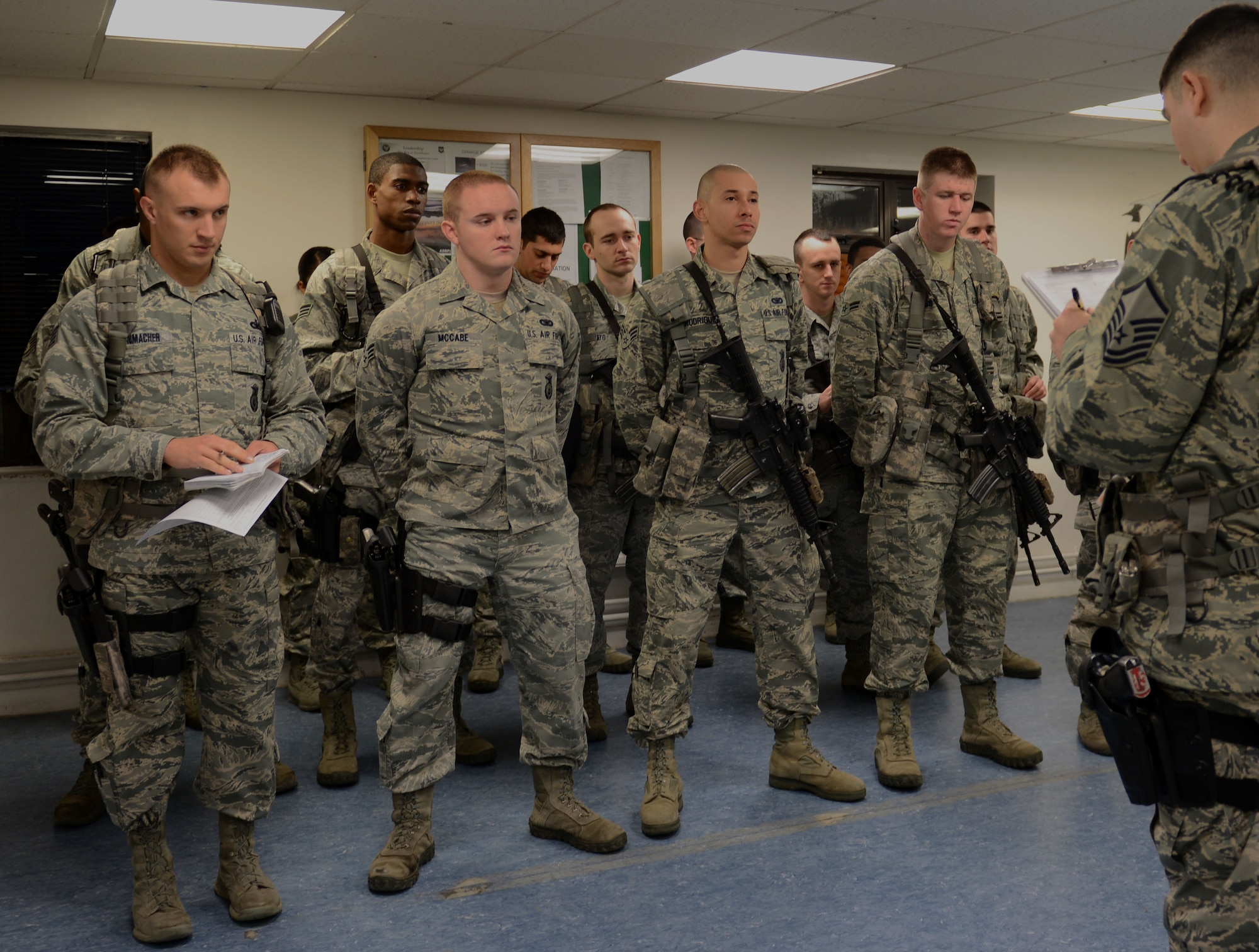 U.S. Air Force Master Sgt. Justin Aguilar, right, 100th Security Forces Squadron flight chief from Escondido, Calif., delivers a briefing March 6, 2014, during guard mount on RAF Mildenhall, England. Prior to each shift, security forces Airmen gather together to receive updates, briefings and necessary information. (U.S. Air Force photo by Airman 1st Class Preston Webb/Released)