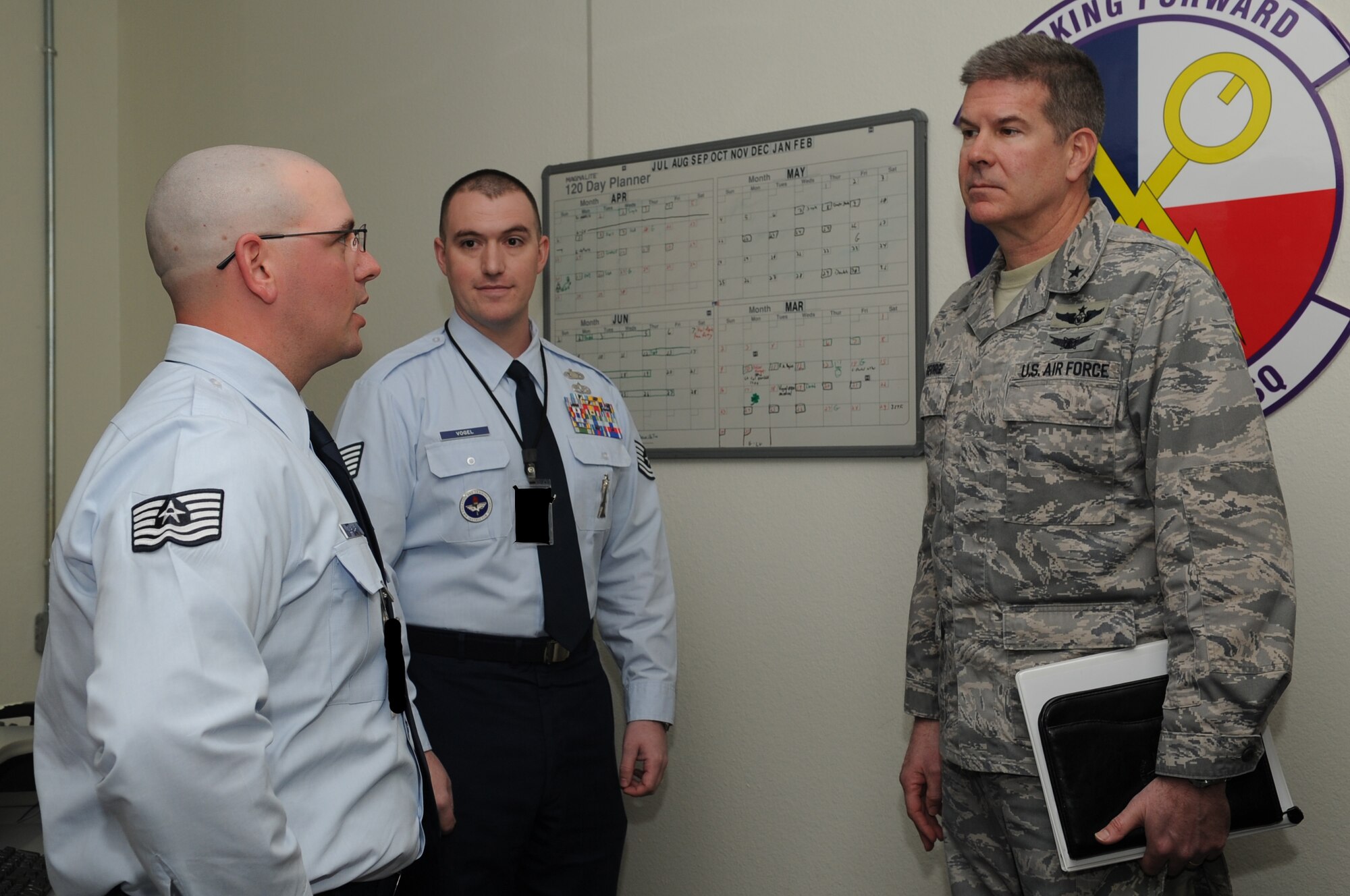 GOODFELLOW AIR FORCE BASE, Texas -- Tech. Sgts. Gerard Gurnari and Carl Vogel, 316th Training Squadron instructors, talk to Brig. Gen. Scott George, National Security Agency Central Security Service deputy chief, on their course during a visit here March 10. George was the 17th Training Group commander from 2006 through 2008 and visited to see how the training has progressed. (U.S. Air Force photo/ Staff Sgt. Laura R. McFarlane)