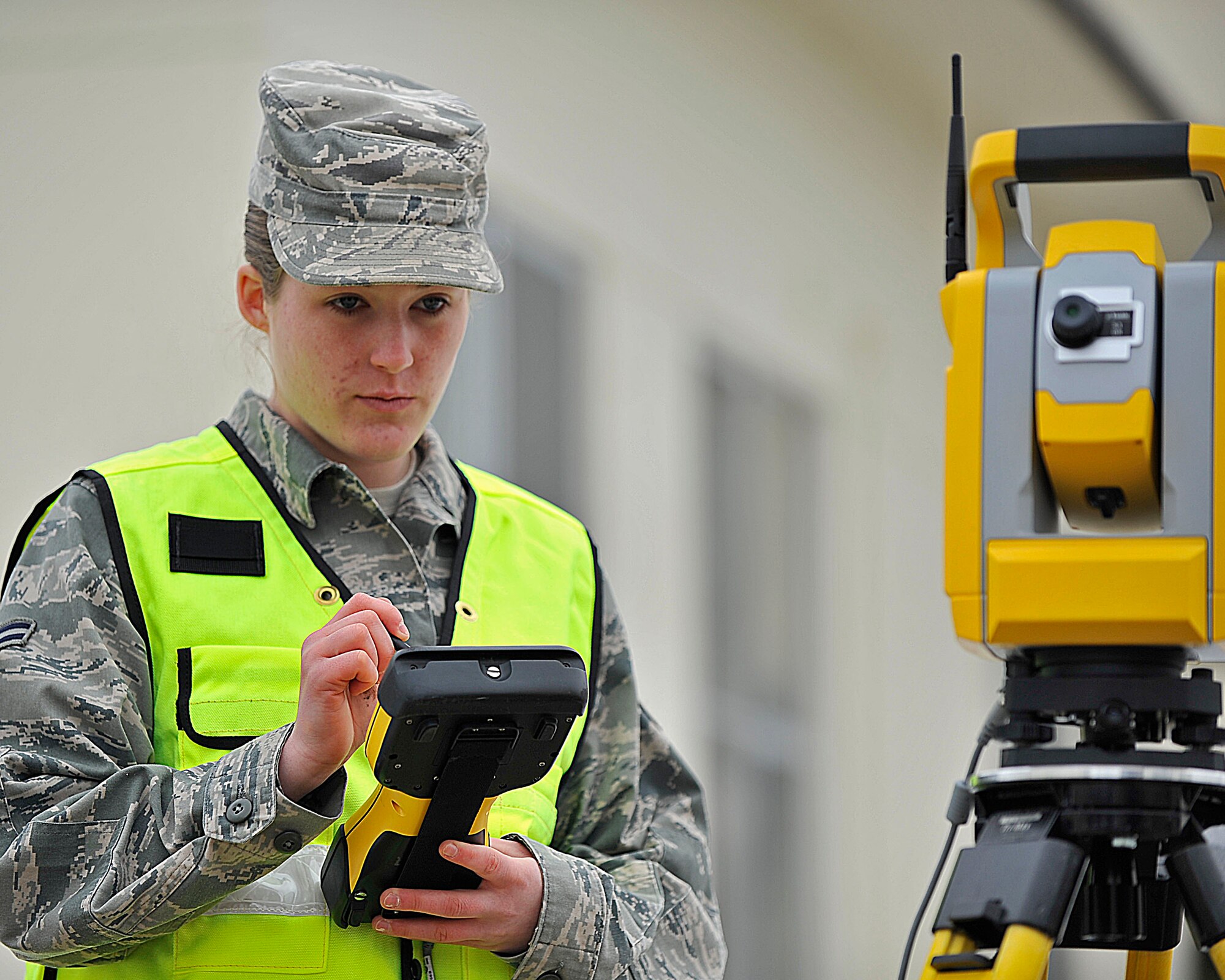 MISAWA AIR BASE, Japan -- U.S. Air Force Airman 1st Class Kherra Etherton, 35th Civil Engineer Squadron engineering apprentice, ensures the total station is facing the right direction before plotting information into the controller at Misawa Air Base, Japan, March 18, 2014. Etherton was recognized as the Wild Weasel of the Week by the 35 CES for her superior performance, outstanding work ethic, and overall good conduct and discipline. (U.S. Air Force photo/ Staff Sgt. Tong Duong)
