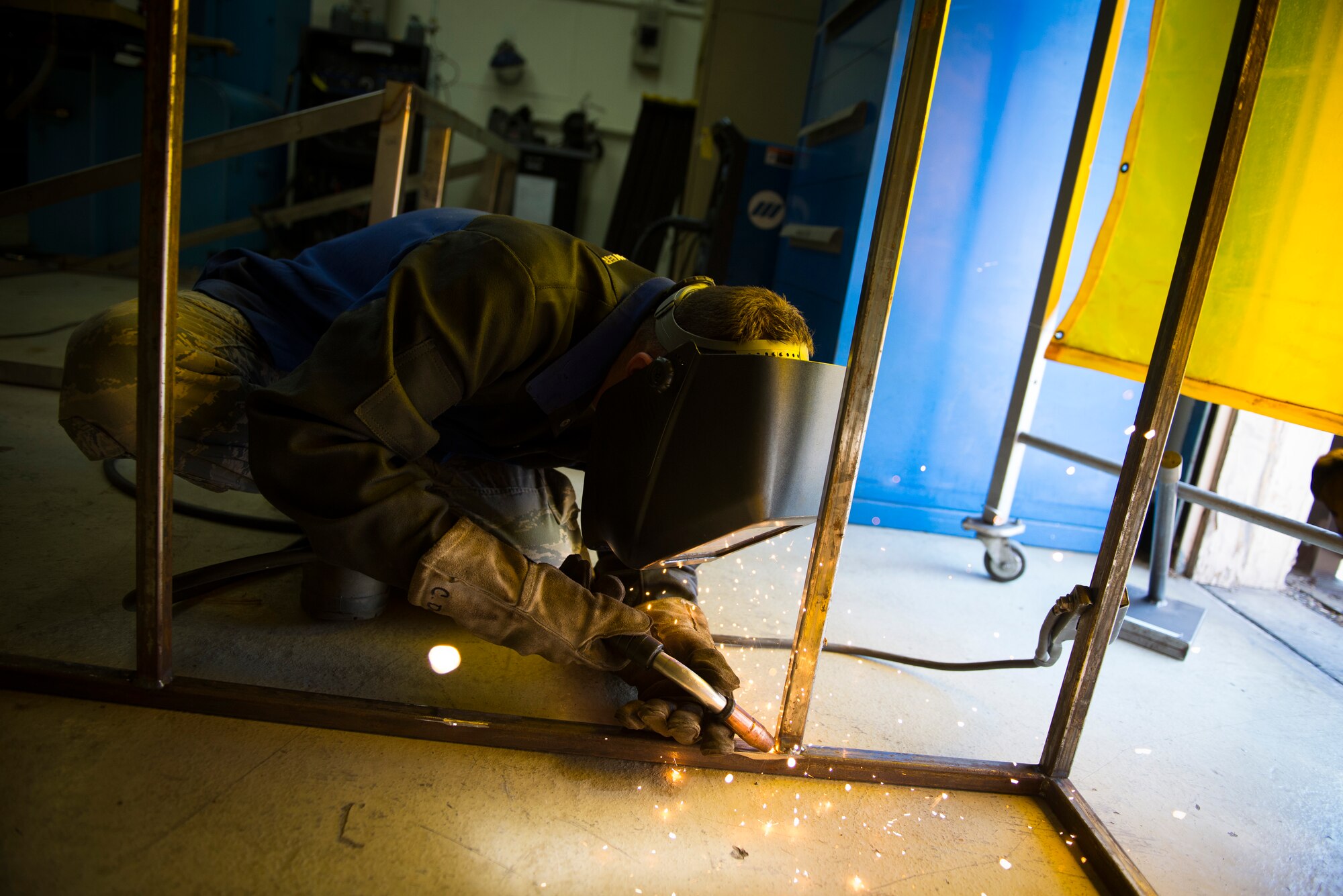 Airman 1st Class Curtis Doherty, 374th Maintenance Squadron aircraft metals technology specialist, welds a section of a metal rack at Yokota Air Base, Japan, Mar. 18, 2014. The rack will be used to store and maintain unused metal, which will increase safety and productivity. (U.S. Air Force photo by Staff Sgt. Chad C. Strohmeyer/Released)