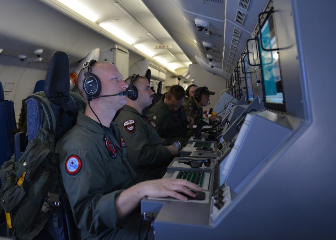 The crew of a P-8A Poseidon assists in the scan and search for a ...