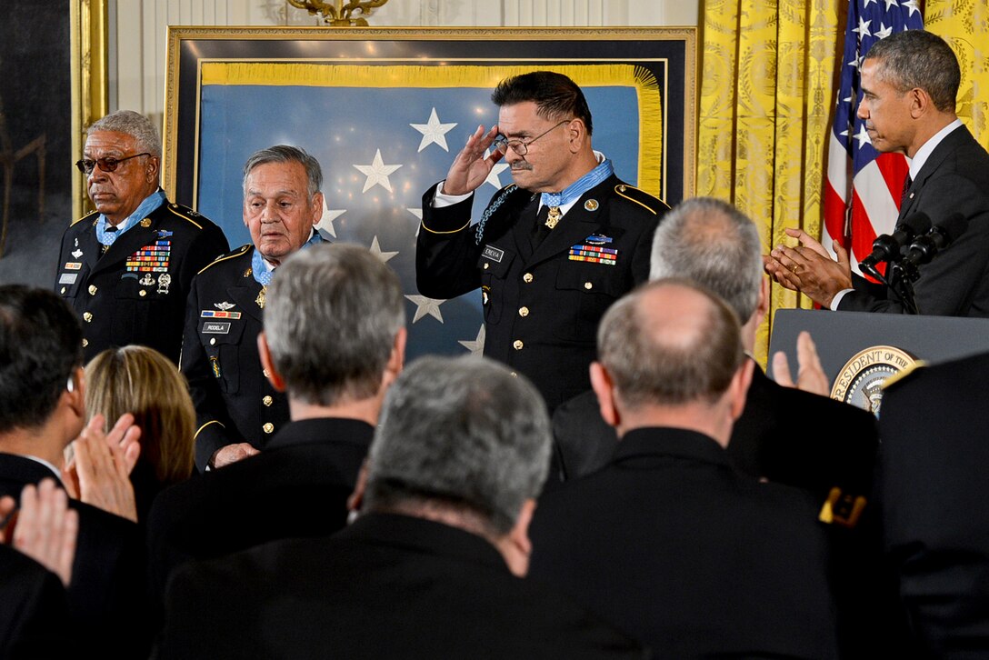 President Barack Obama, far right, applauds the newest living recipients of the Medal of Honor, Army Sgt. 1st Class Melvin Morris, left, Master Sgt. Jose Rodela, center, and Sgt. Santiago J. Erevia, during a ceremony at the White House in Washington, D.C., March 18, 2014.