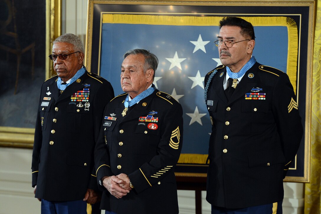 The newest living recipients of the Medal of Honor, Army Sgt. First Class Melvin Morris, left, Master Sgt. Jose Rodela, center, and Sgt. Santiago J. Erevia, stand during a ceremony at the White House in Washington, D.C., March 18, 2014.