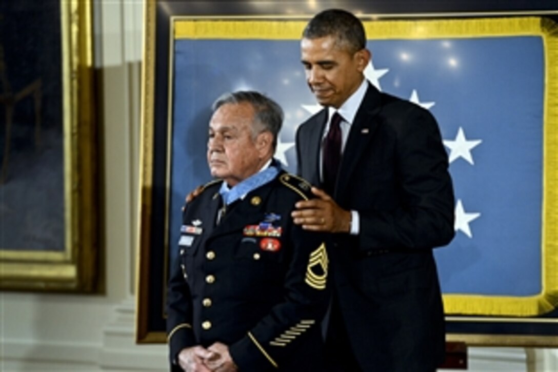 President Barack Obama awards the Medal of Honor to Army Master Sgt. Jose Rodela during a ceremony at the White House, March 18, 2014. Rodela received the medal for actions during combat operations against an armed enemy in Phuoc Long province in Vietnam, Sept. 1, 1969. 