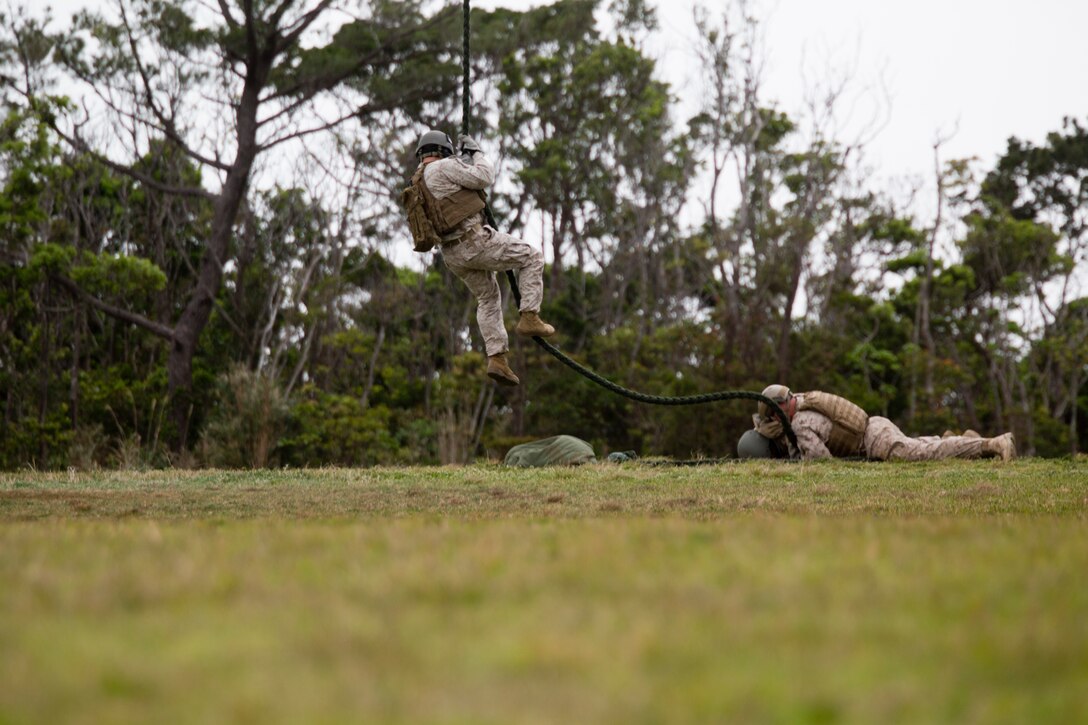 Marines execute fast roping out of an MV-22B Osprey tiltrotor aircraft March 12 during training at Camp Schwab, Okinawa. With this technique Marines can execute tactical insertions where rotary aircraft landings are impractical, according to Marine Corps Reference Publication 3-11.4A. The Marines are with Force Reconnaissance Company, 3rd Reconnaissance Battalion, 3rd Marine Division, III Marine Expeditionary Force.
