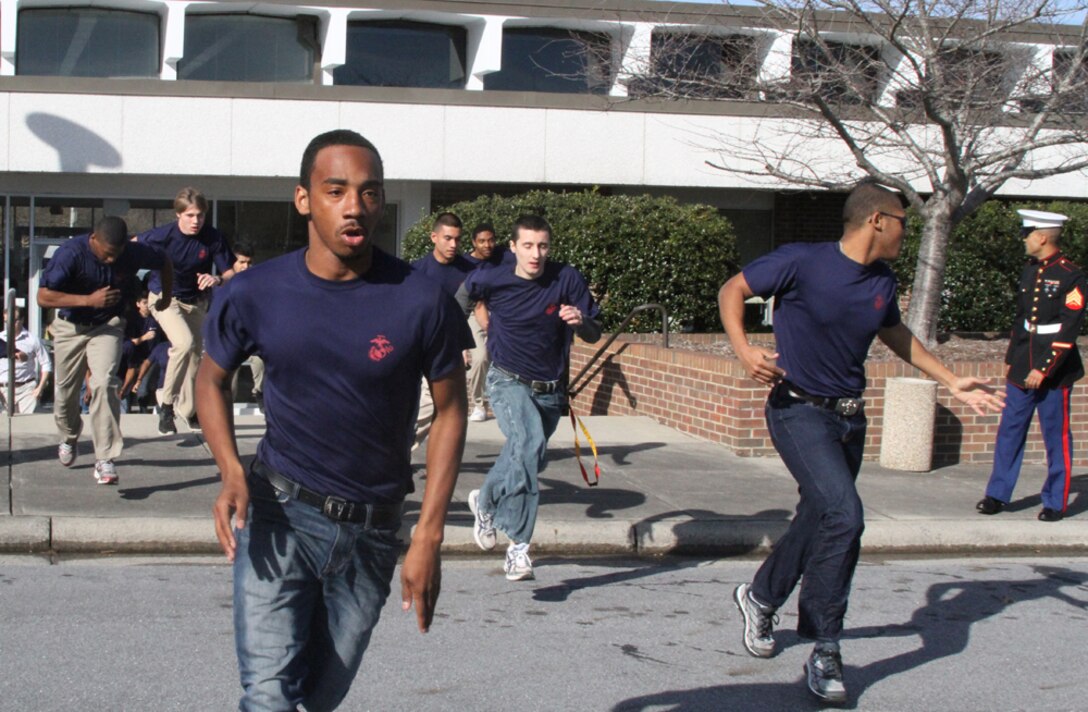 Poolees from Recruiting Sub-Station Greenville run to get into formation during a family night at the East Carolina University Willis Buildings in Greenville, N.C., March 8, 2014. Family nights are a time for the families of the applicants to come together, meet the Marines of the Sub-Station, learn about the Marine Corps and the process of boot camp. 