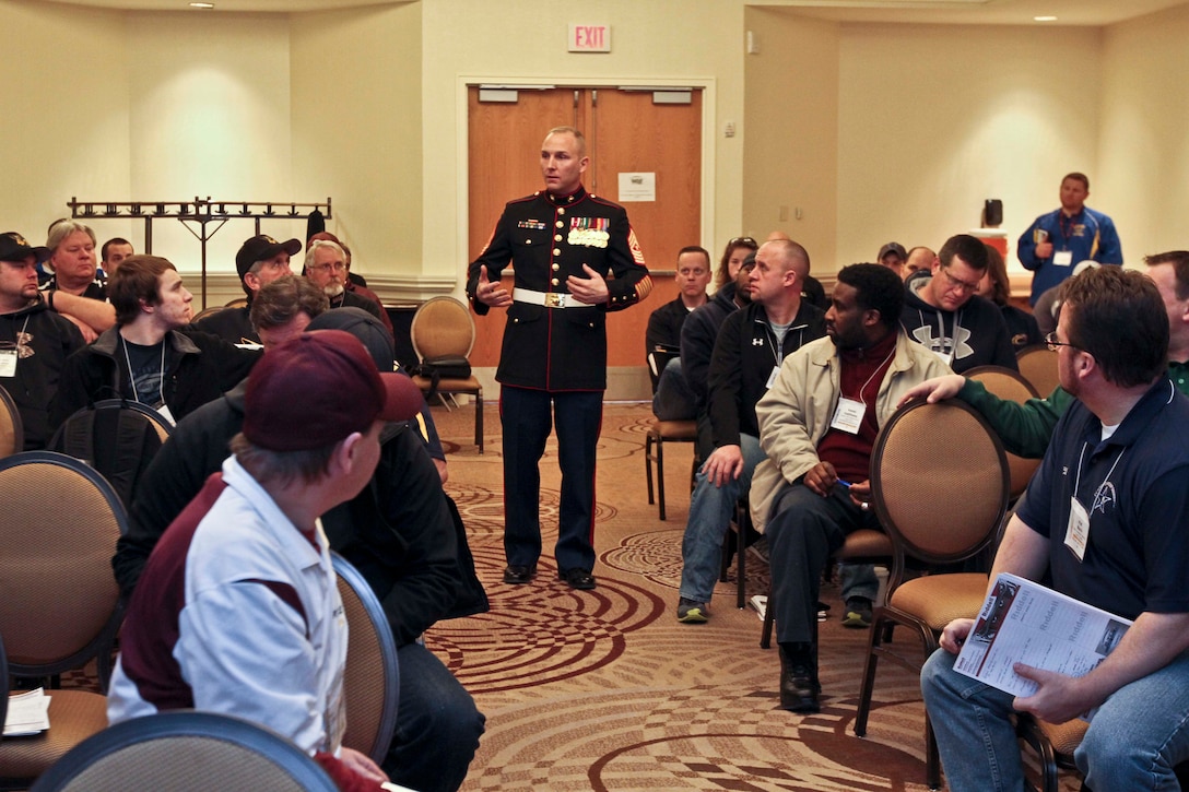 U.S. Marine Corps Sgt.Maj. Adam Yakubsin, sergeant major of Recruiting
Station Detroit and native of Gainesville, Fla., addresses local high school football coaches during a Glazier Football Clinic at Sheraton Hotel, Novi, Mich., Feb. 14, 2014. Glazier Clinics travel to 34 cities across the country in 2014 to provide coaches with advanced football knowledge to further advance their respective programs. (US Marine Corps photo by Sgt. Elyssa Quesada/Released)
