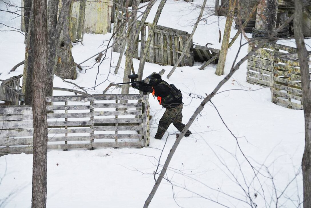 U.S. Marine Corps Staff Sgt. Jorge Santiago, Recruiting Substation Winchester staff noncommissioned officer in charge, takes a tactical position during a paintball pool function in Winchester, Va. Feb 15, 2014. A pool function occurs once a month and is designed to improve the fitness, leadership and camaraderie of the poolees before shipping to recruit training on Marine Corps Recruit Depot Parris Island, S.C.