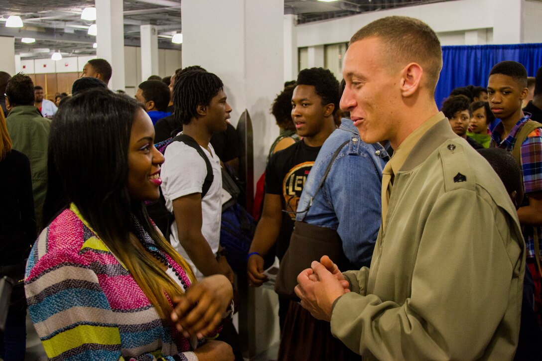 U.S. Marine Corps Sgt. Travis Burch, a recruiter with RSS Chesapeake, speaks to a student about available Marine Corps career options at the Scope Arena in Norfolk, Va. March 12, 2014. The Marine Corps is committed to making concerted efforts to attract, mentor, and retain the most talented men and women who bring a diversity of background, culture and skill in service to our nation. (U.S. Marine Corps photo by Lance Cpl. Jacky Fang/Released)