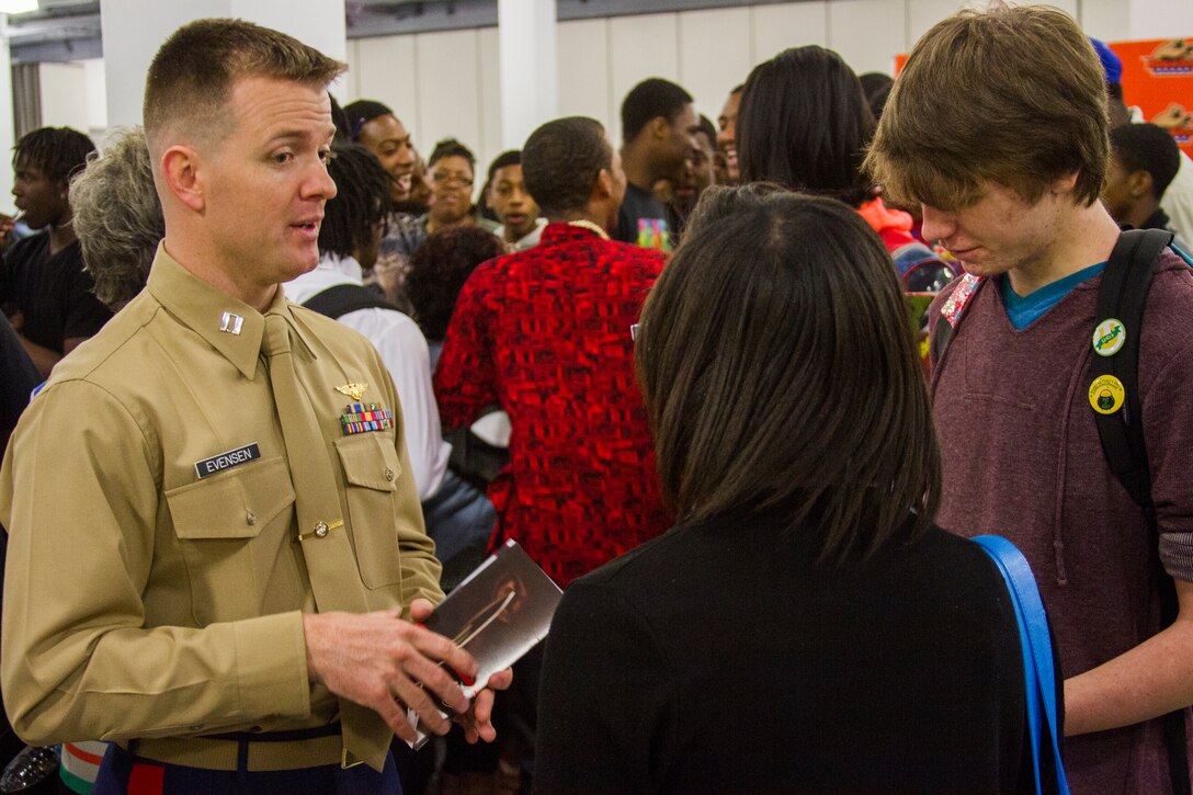 U.S. Marine Corps Capt. James Evensen, assistant diversity officer, Marine Corps Recruiting Command,  speaks to students about various job fields the Marine Corps has to offer at the Mid-Eastern Athletic Conference Basketball Tournament at the Scope Arena in Norfolk, Va. March 12, 2014. The Marine Corps is committed to making concerted efforts to attract, mentor, and retain the most talented men and women who bring a diversity of background, culture and skill in service to our nation. (U.S. Marine Corps photo by Lance Cpl. Jacky Fang/Released)