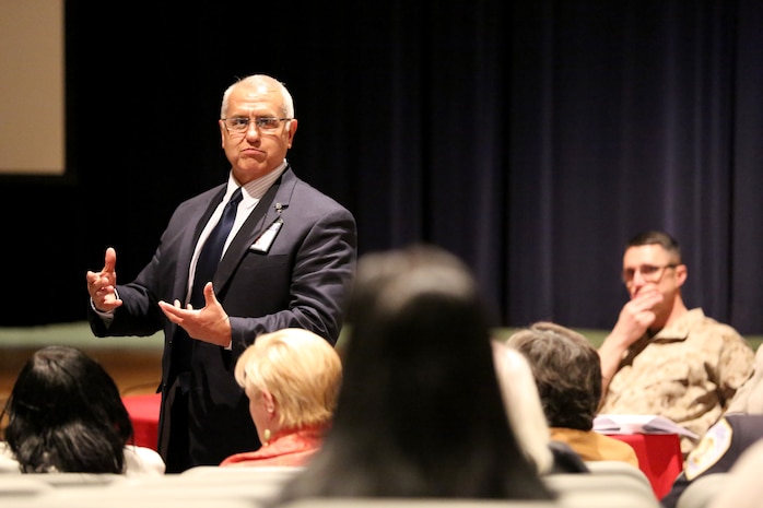 Emilio Garza, Principal of Brewster Middle School, explains details of a proposed Lejeune High School dress code to parents, teachers and students at a town hall meeting aboard Marine Corps Base Camp Lejeune, March 13. Members of the the community gathered at the Lejeune High school auditorium to ensure their voices were heard during the meeting. Topics included the proposed school dress code and the common core state standards.