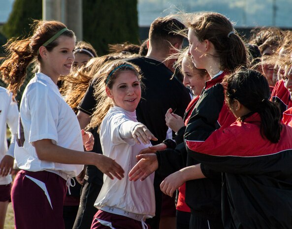 Matthew C. Perry High School Lady Samurai soccer team memberrs and E. K. King High School Lady Cobras team members shake hands after a game that took place at Penny Lake Field aboard Marine Corps Air Station Iwakuni, Japan, March 14, 2014. Being a part of a sports team gives students a chance to explore different parts of the pacific region.