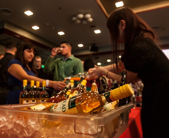 A Marine Corps Community Services worker pours a drink for a Red, White & Food Wine Festival patron during the event that took place in the Club Iwakuni ballroom aboard Marine Corps Air Station Iwakuni, Japan, March 15, 2014. More than 100 types of wine were offered during the festival.