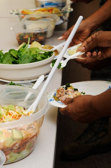 Airmen participate in the Health and Wellness Center’s healthy cooking demonstration on Kadena Air Base, Japan, March 19, 2014. Airmen were taught how to make quick meals while using a microwave, such as salmon with a loaded potato, homemade sweet potato chips, southwestern bean dip and fruit infused water. (U.S. Air Force photo by Senior Airman Marcus Morris)