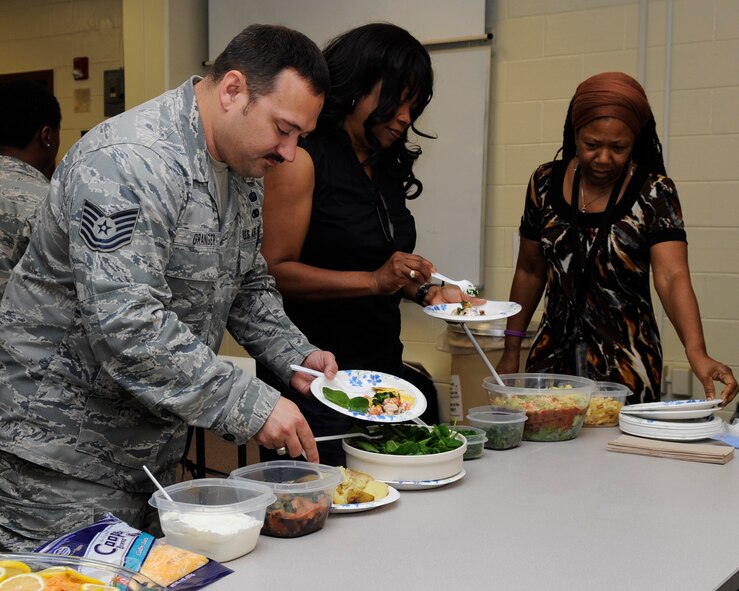 Airmen participate in the Health and Wellness Center’s healthy cooking demonstration on Kadena Air Base, Japan, March 19, 2014. The Airmen were taught how to use a microwave to make quick and healthy meals, such as salmon with a loaded potato, homemade sweet potato chips, southwestern bean dip and fruit infused water. (U.S. Air Force photo by Senior Airman Marcus Morris)