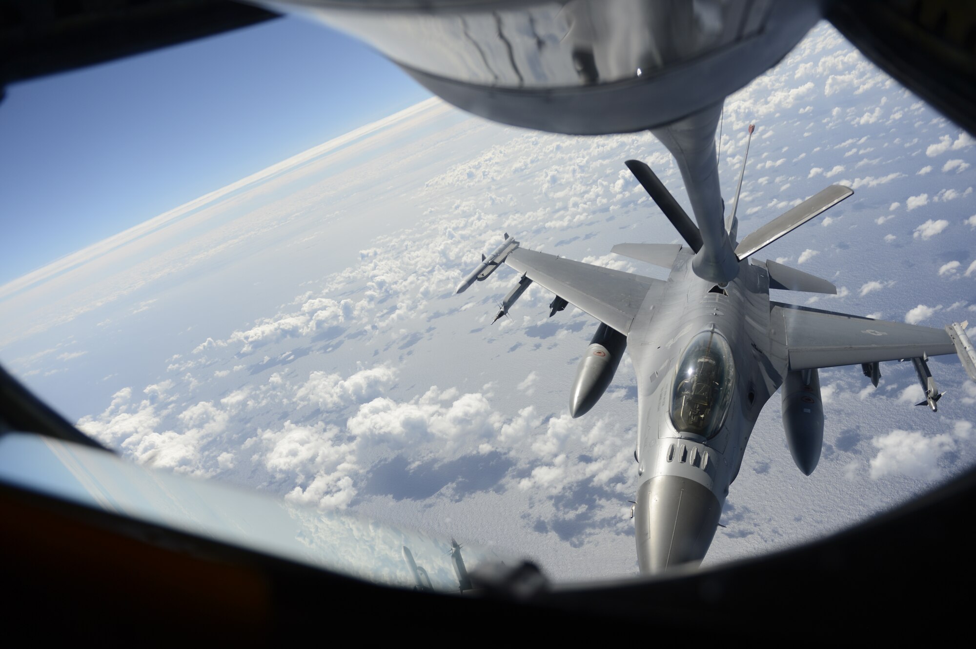 An F-16 Fighting Falcon refuels over the Pacific Ocean in support of exercise Cope North 2014, Andersen Air Force Base, Guam, Feb. 25, 2014. During this event, the aviators train on war-fighting integration tactics. Cope North is a multilateral aerial and humanitarian assistance and disaster relief exercise, held annually, designed to increase the combat readiness and interoperability of the U.S. Air Force, Japanese Air Self Defense Force, and Royal Australian Air Force.