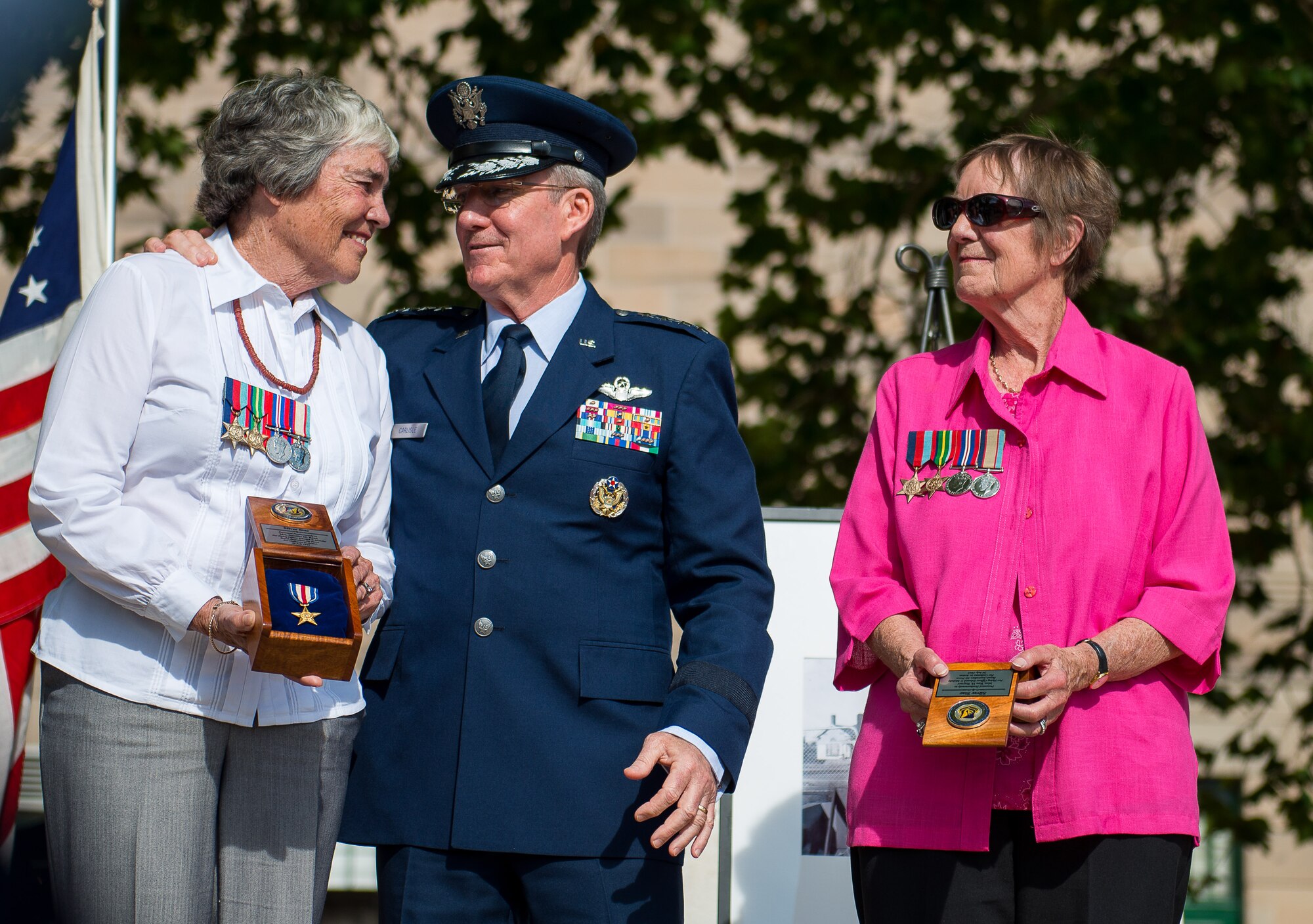 Royal Australian Air Force Flying Officer Edward Thompson Mobsby’s twin daughters, Jennifer Read and Rae Rayner, are honored by Gen. Hawk Carlisle, Pacific Air Forces commander, during a Silver Star Medal ceremony at the Australian War Memorial in Canberra, Australia, March 14, 2014. Read and Rayner, Mobsby’s twin daughters, accepted the medal on behalf of their father, who passed away 72 years ago during a battle over Papua New Guinea. The other four servicemembers killed with Mobsby were awarded medals in 1942 and 1943. (Photo courtesy of the U.S. Embassy in Canberra)