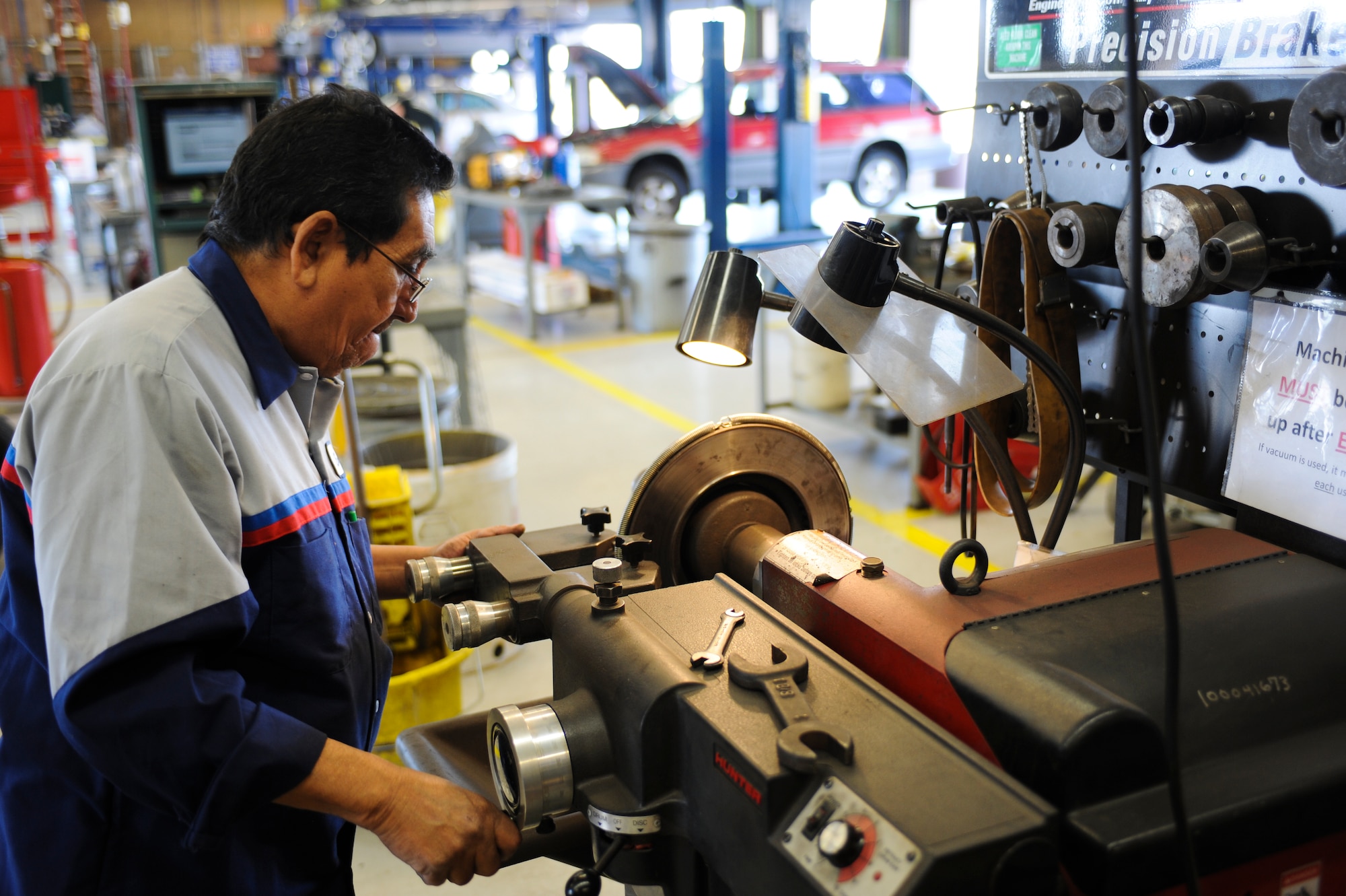 Enrique Kincaid, 355th Force Support Squadron mobile equipment services technician, turns a rotor at the Auto Hobby Shop during a brake inspection at Davis-Monthan Air Force Base, Ariz., March 18, 2014. The Auto Hobby Shop here offers technical services, auto towing, tune-ups and several of other services at a lower price than local repair shops. (U.S. Air Force photo by Senior Airman Sivan Veazie/Released)
