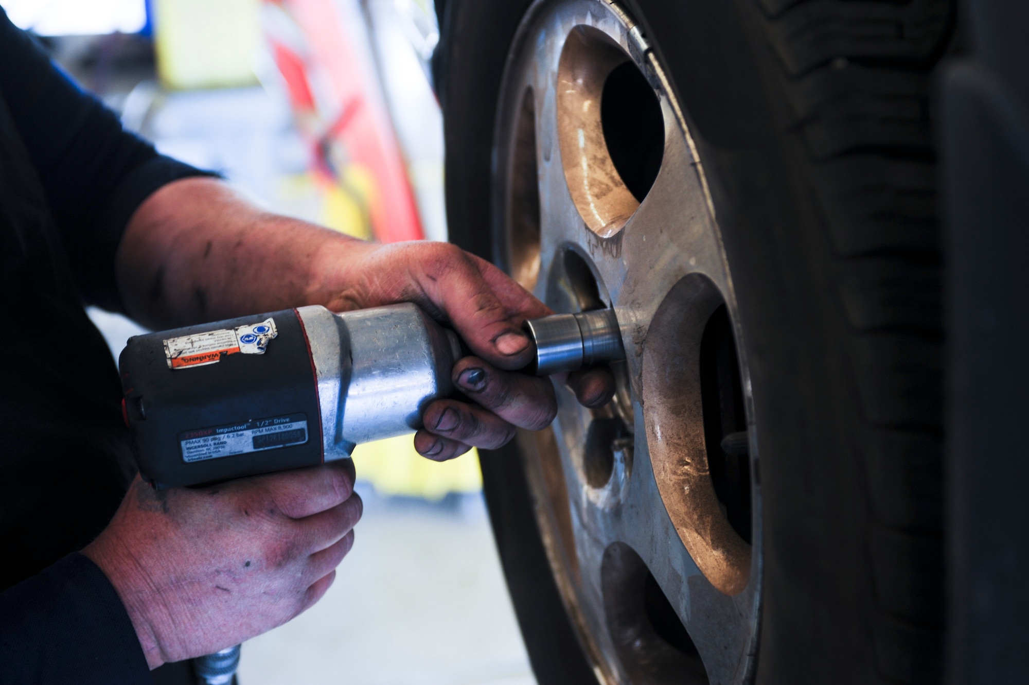 Robert Martin, Auto Hobby Shop contract mechanic, takes the lug nuts off a vehicle at the Auto Hobby Shop for a brake inspection at Davis-Monthan Air Force Base, Ariz., March 18, 2014. The shop offers13 indoor maintenance lift stalls and five regular stalls, as well as an array of specialized automotive tools, a car wash, vacuum center and a paint booth. (U.S. Air Force photo by Senior Airman Sivan Veazie/Released)
