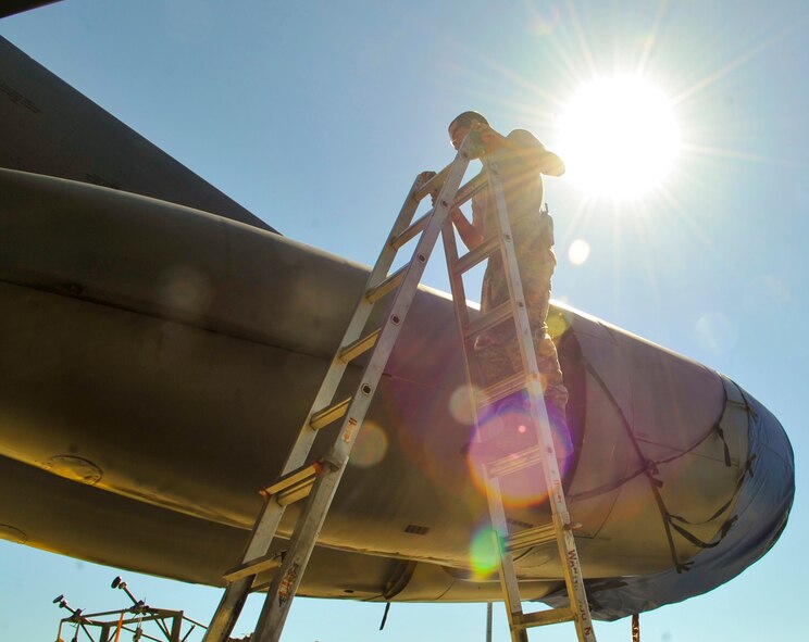 Senior Airman Andrew Mathews, 2nd Maintenance Squadron aircraft structural maintenance journeyman, climbs a ladder to inspect the top part of a B-52H Stratofortress engine on Barksdale Air Force Base, March 13, 2014. "I'm exposed to the elements every day," said Mathews. "No matter how hot or how cold it is, I'm going to be out there working." (U.S. Air Force photo/Airman 1st Class Benjamin Raughton)